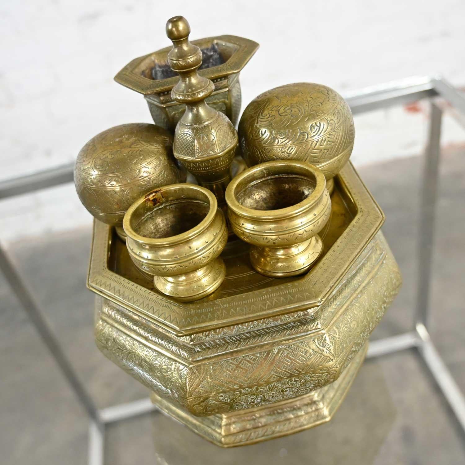 Phenomenal vintage East Java Indonesian brass Tepak Sireh betel nut set including a large brass bowl with removeable lid which doubles as a tray, two rounded containers with lids, two smaller vessels without lids, and a narrow vessel, all with