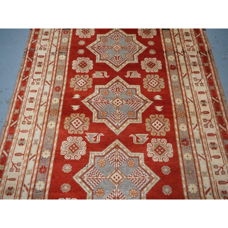 Woven Antique East Turkestan Khotan Rug With Three Star Medallions, Circa 1920 For Sale