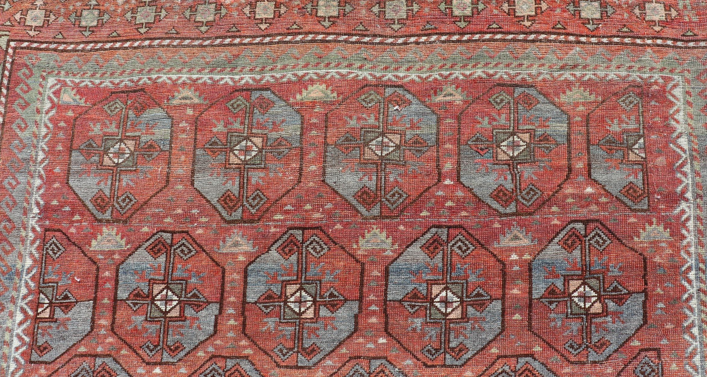 Measures: 5'10 x 8'10 
This antique East Turkistan Belouch rug is a stunning representation of traditional craftsmanship, featuring a rich red lattice pattern that is both striking and symbolic. The rug is beautifully ornamented with a network of