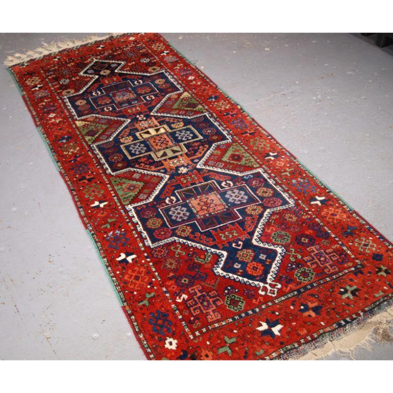 Antique Eastern Anatolian Kurdish Yuruk long rug with three medallion design.

An good example of a Yuruk long rug, with a classic design of three linked medallions and traditional colour palette. The apricot / orange used in the border is