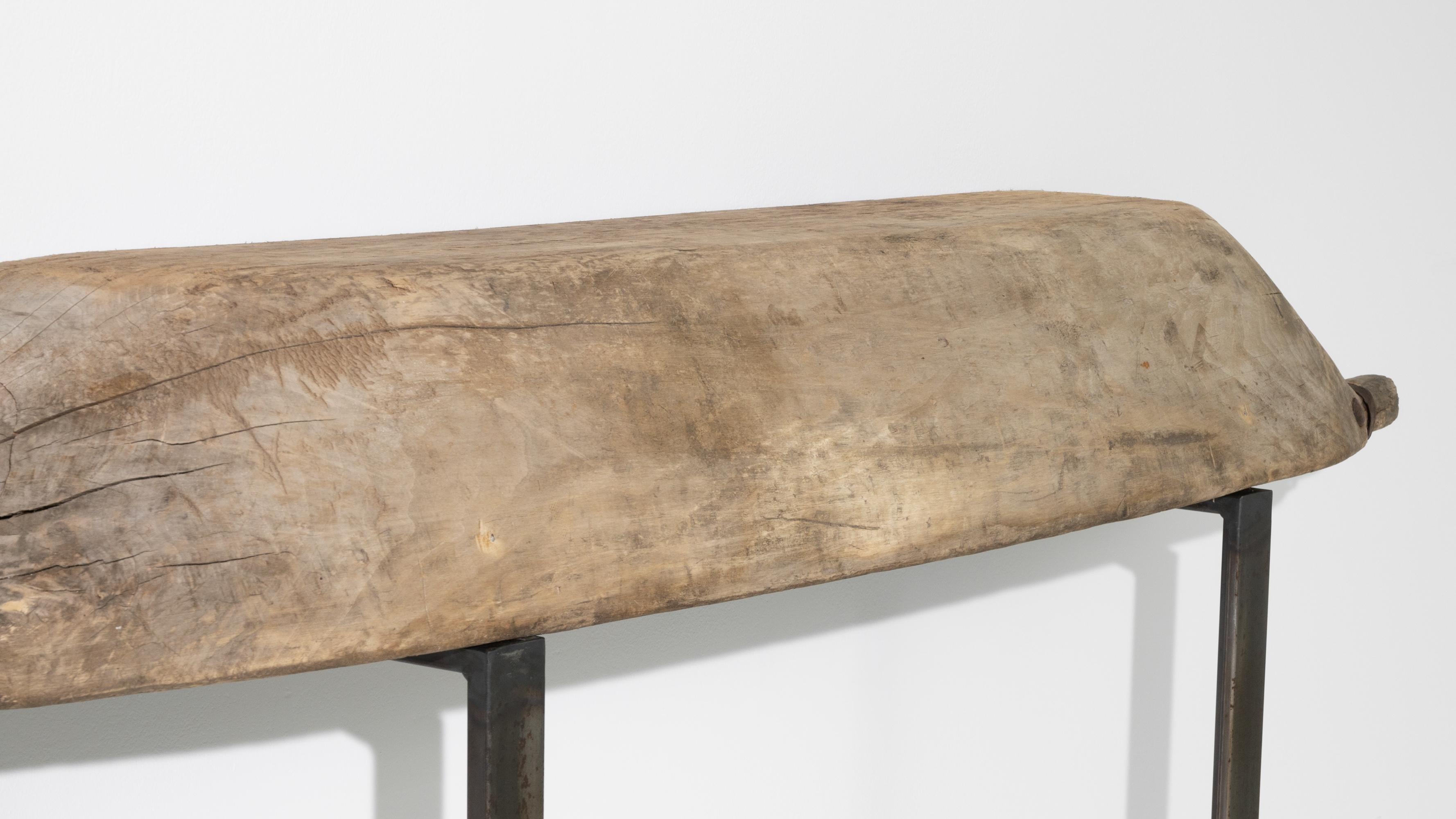 This antique metal console with a wooden top
was crafted in Poland. A concave wooden mixing bowl, made circa 1800; resembles a half cut pirogue, elevated on two perpendicular metal legs to shape a unique styled console. Original iron junctions