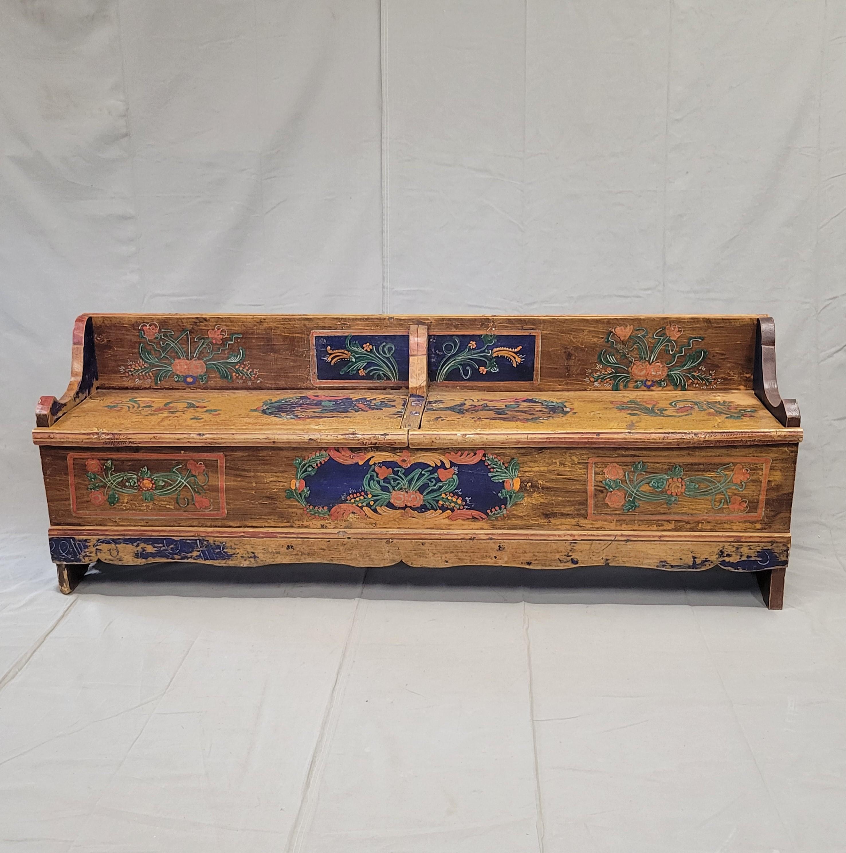 This charming and functional antique Eastern European (Romanian) hand painted pine long storage bench would be a stunning focal point in almost any room. It likely dates to the late 1800s or early 1900s and the paint is original. Note the wear in