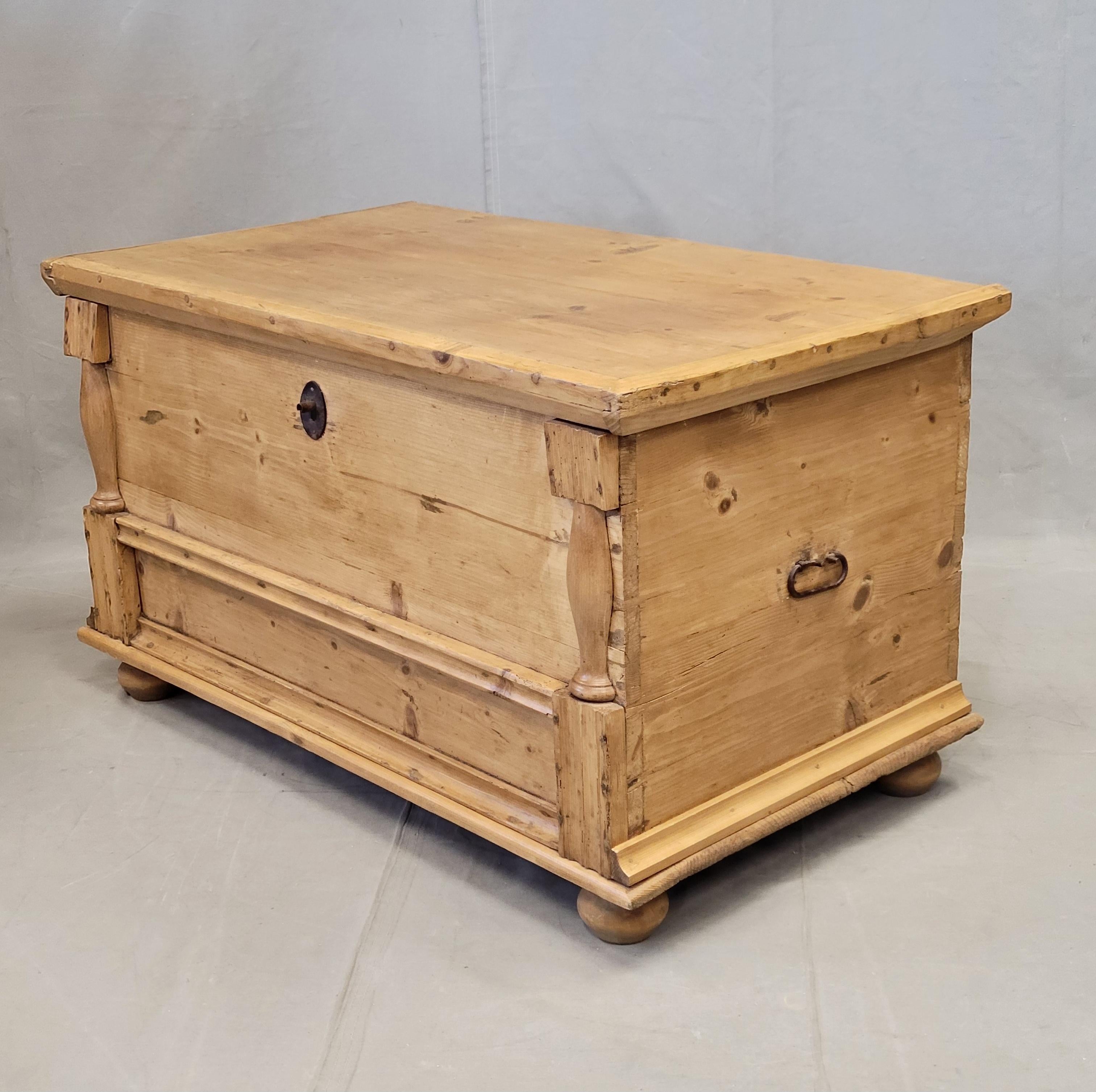 A charming and functional antique eastern European rustic pine blanket chest. Pilasters at the corners and applied mouldings give this piece such character. Old iron keyhole and handles. This piece would add rustic European charm to any space... at