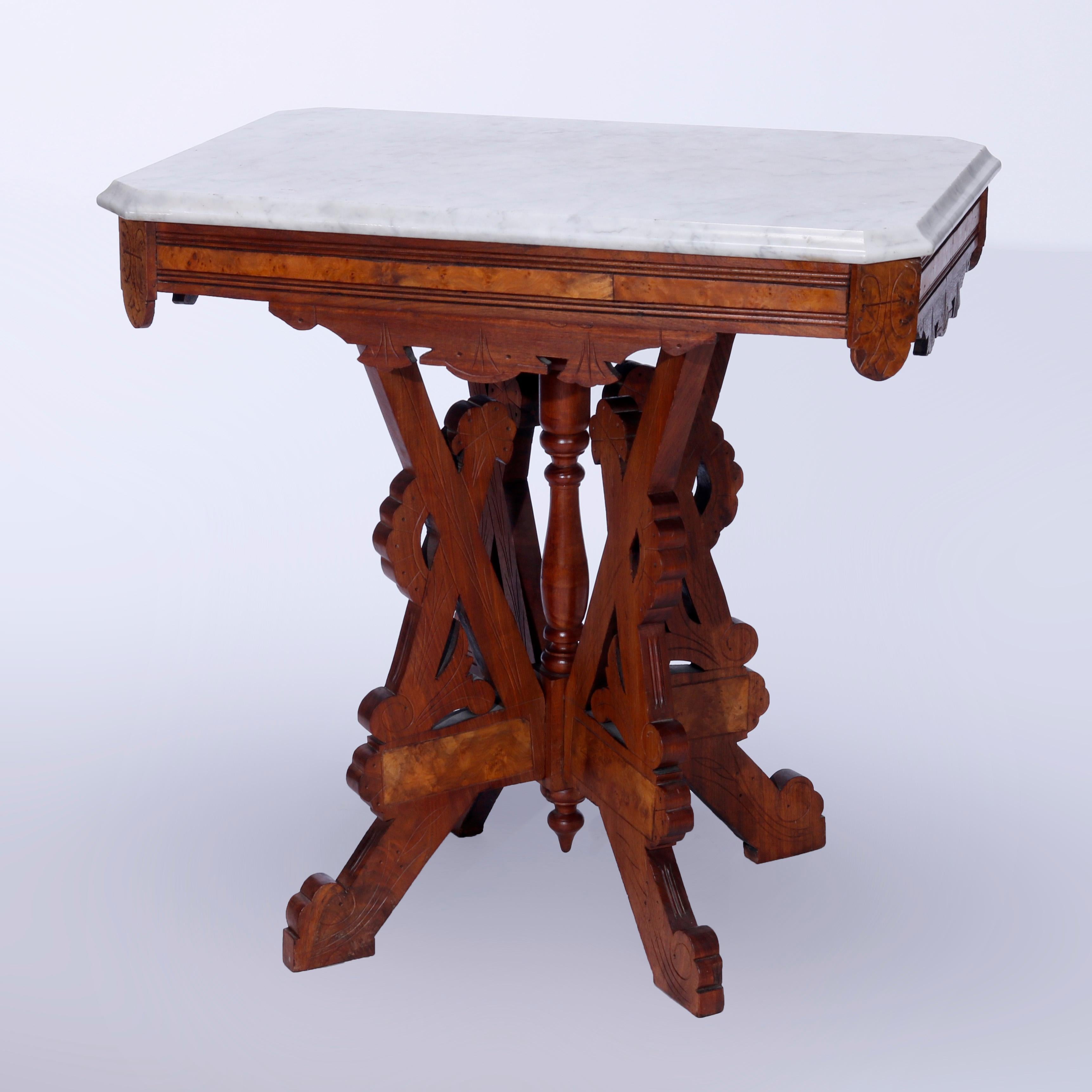 An antique Eastlake parlor table offers beveled clip-corner top over a walnut base having burl inset, shaped skirt and incised scroll decoration, raised on cut-out legs with central turned column and lower drop finial, c1890

Measures - 28.5''H x