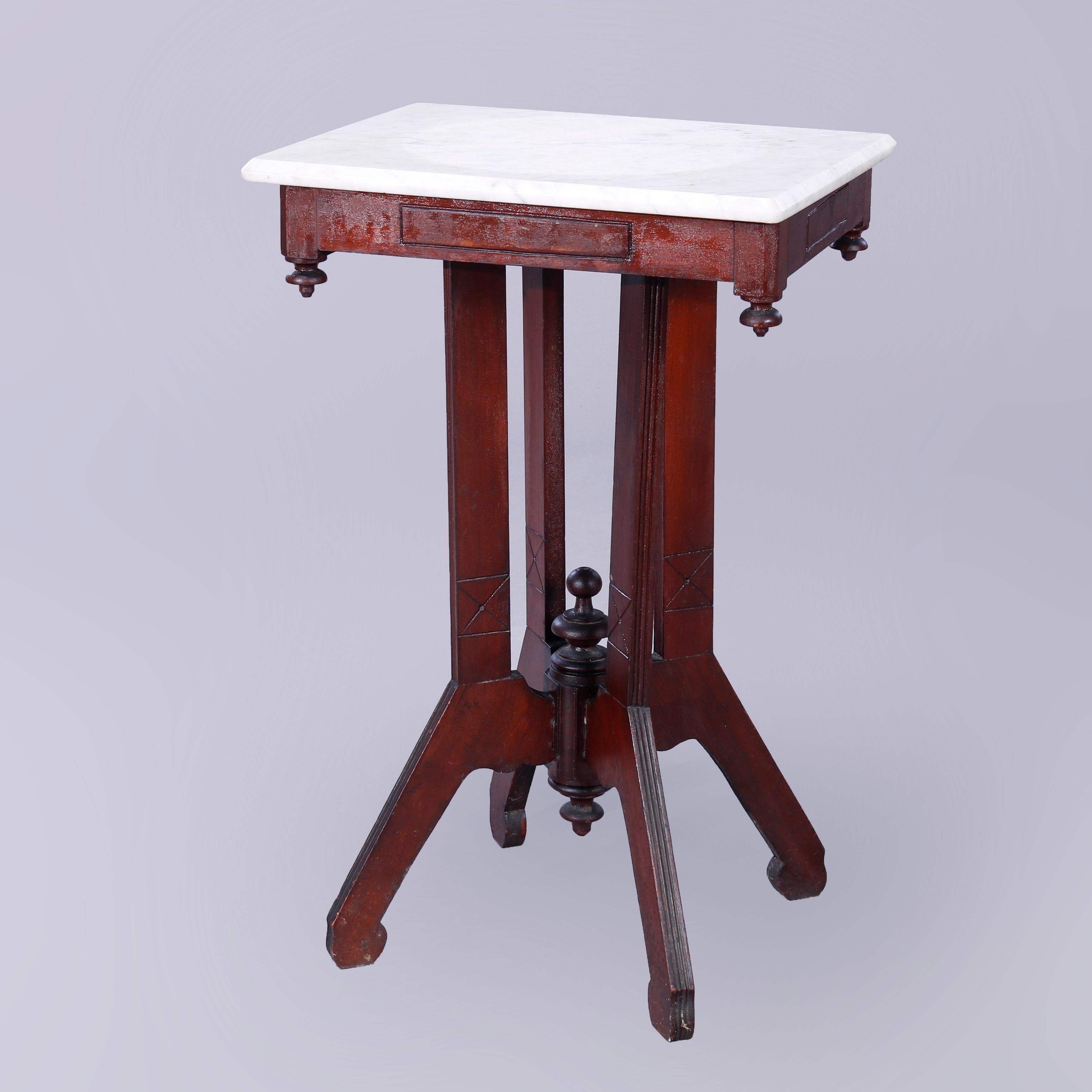 An antique Eastlake side stand offers beveled marble top over incised walnut base with drop corner finials and raised on flared reeded legs with central turned finials, c1890

Measures - 29.25''h x 18.5''w x 14.25''d.