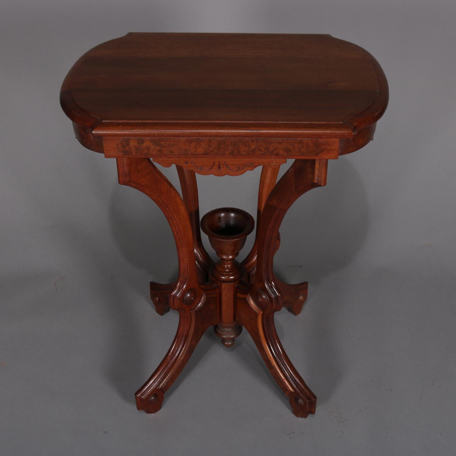 Antique Eastlake lamp stand features carved walnut construction with shaped and bevelled top over skirt with burl reserves and raised on convex legs with burl reserves which converge to support central upper chalice form finial surmounting a drop