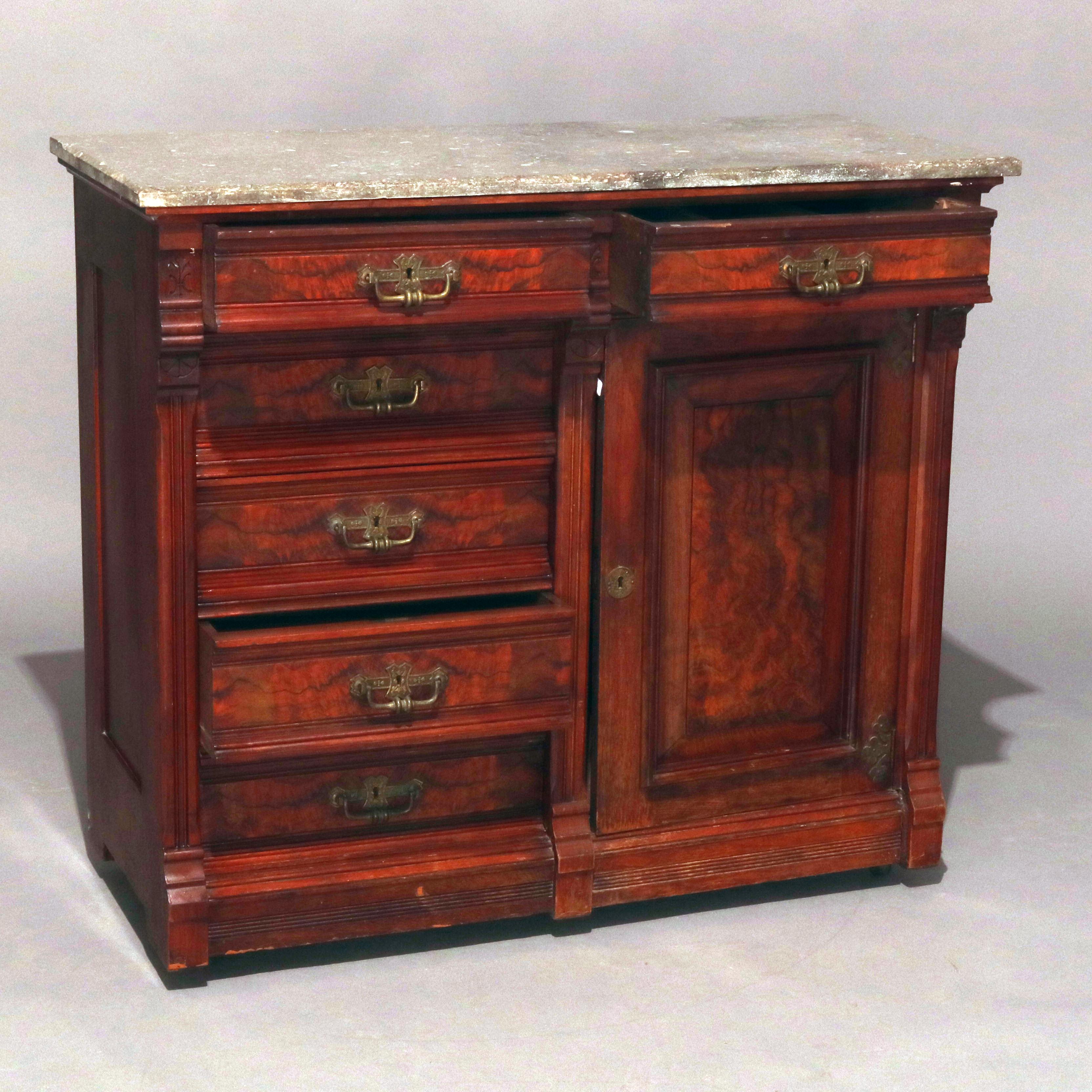 An antique Victorian Eastlake petite server features marble top surmounting mahogany case with drawers and cabinet each having cast bronze hardware, circa 1880.

Measures: 37