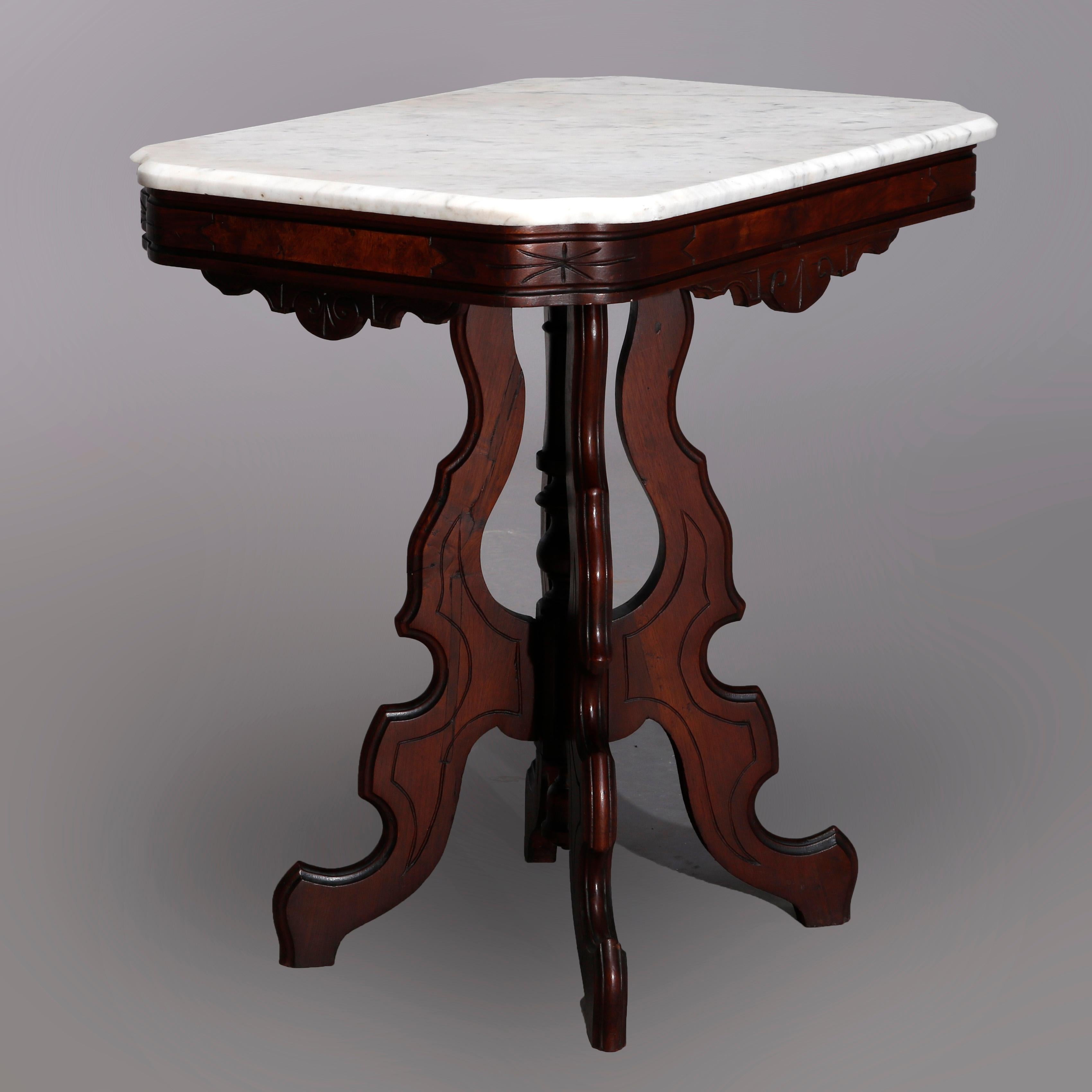 An antique Eastlake side table offers beveled clip corner marble top surmounting walnut base having scroll incised skirt raised on shaped legs with central turned column, c1890

Measures: 29