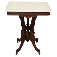 Mesa antigua de estilo Eastlake, de nogal tallado y con tablero cuadrado de mármol, de alrededor de 1890