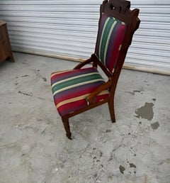 Antique Eastlake chair with casters on front legs