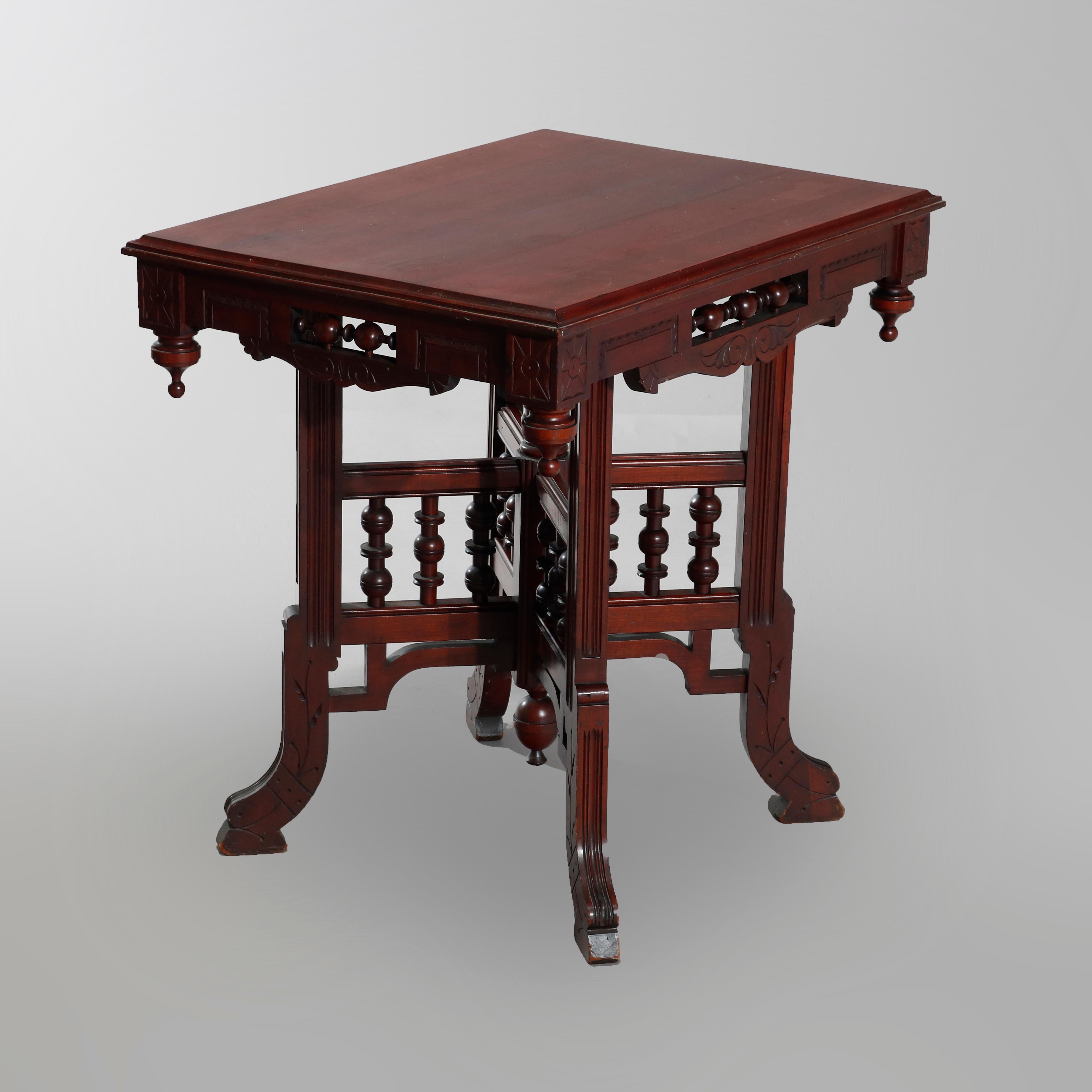 An antique Eastlake parlor lamp table offers cherry construction with top with stick and ball skirt and drop finials surmounting X-form base with stick and ball spindles, circa 1890

Measures: 28.63