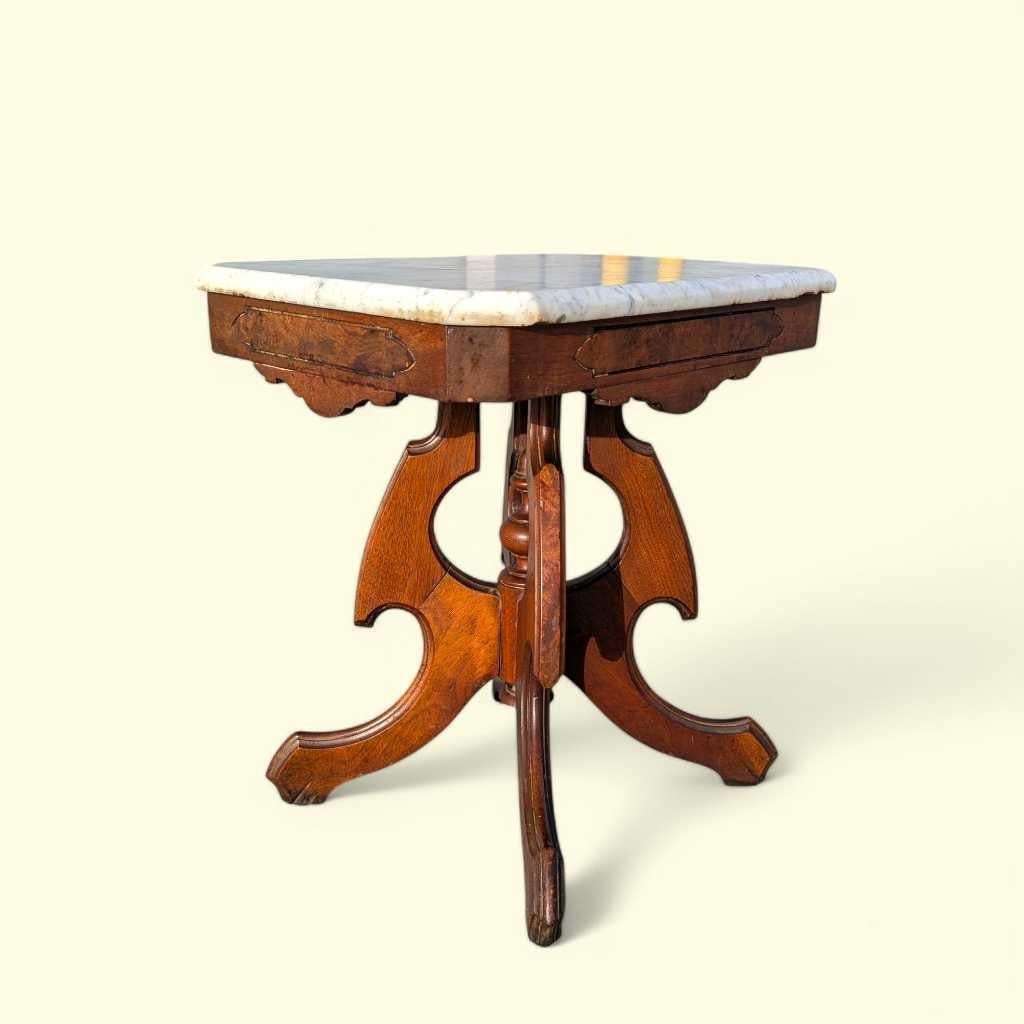 Elegant late-19th-century Eastlake side table, handcrafted in solid walnut and topped with a polished white marble surface. The design reflects the Eastlake movement’s refined interpretation of Victorian style—geometric, architectural, and