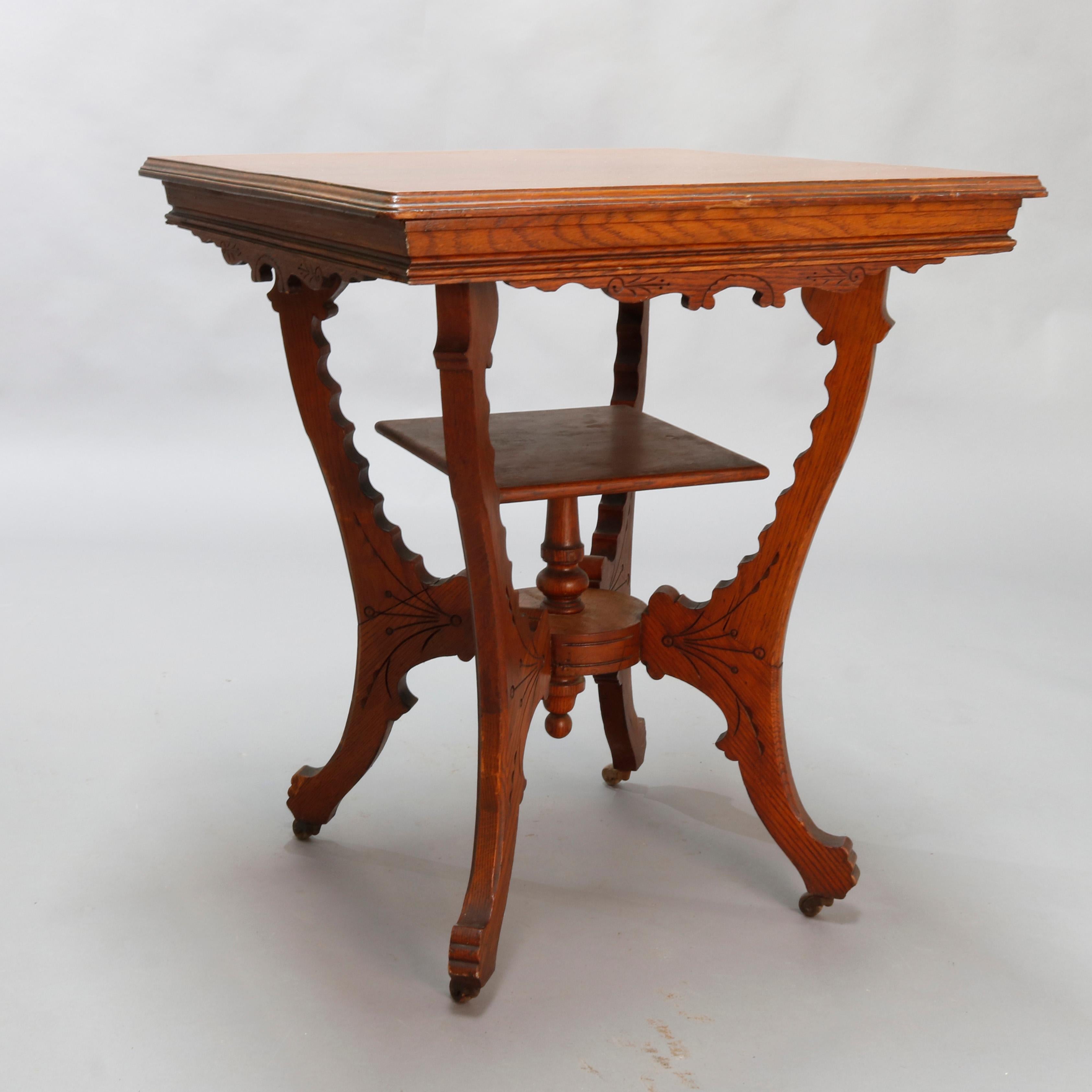 An antique Eastlake Regina music box stand offers oak construction with a shaped and foliate incised skirt raised on scalloped legs having a central display shelf raised on turned column with drop finial, circa 1900.

Measures- 30