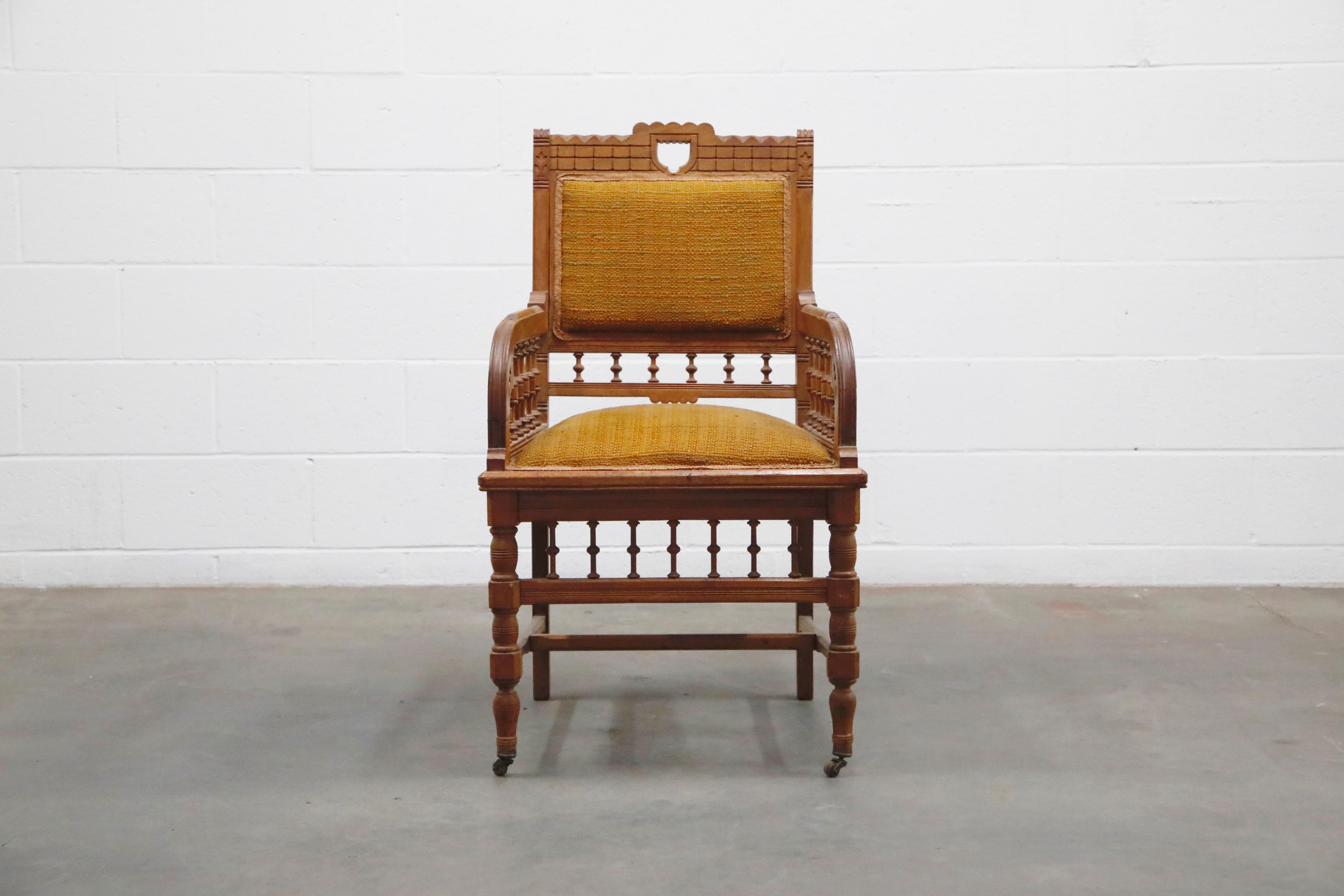 Antique Eastlake oak armchair with fabric seat and seat-back on top of front caster legs. Interesting carved detailing and turned wood posts. Would make a great hall-chair or study room armchair.

This beautiful 19th century chair would work great