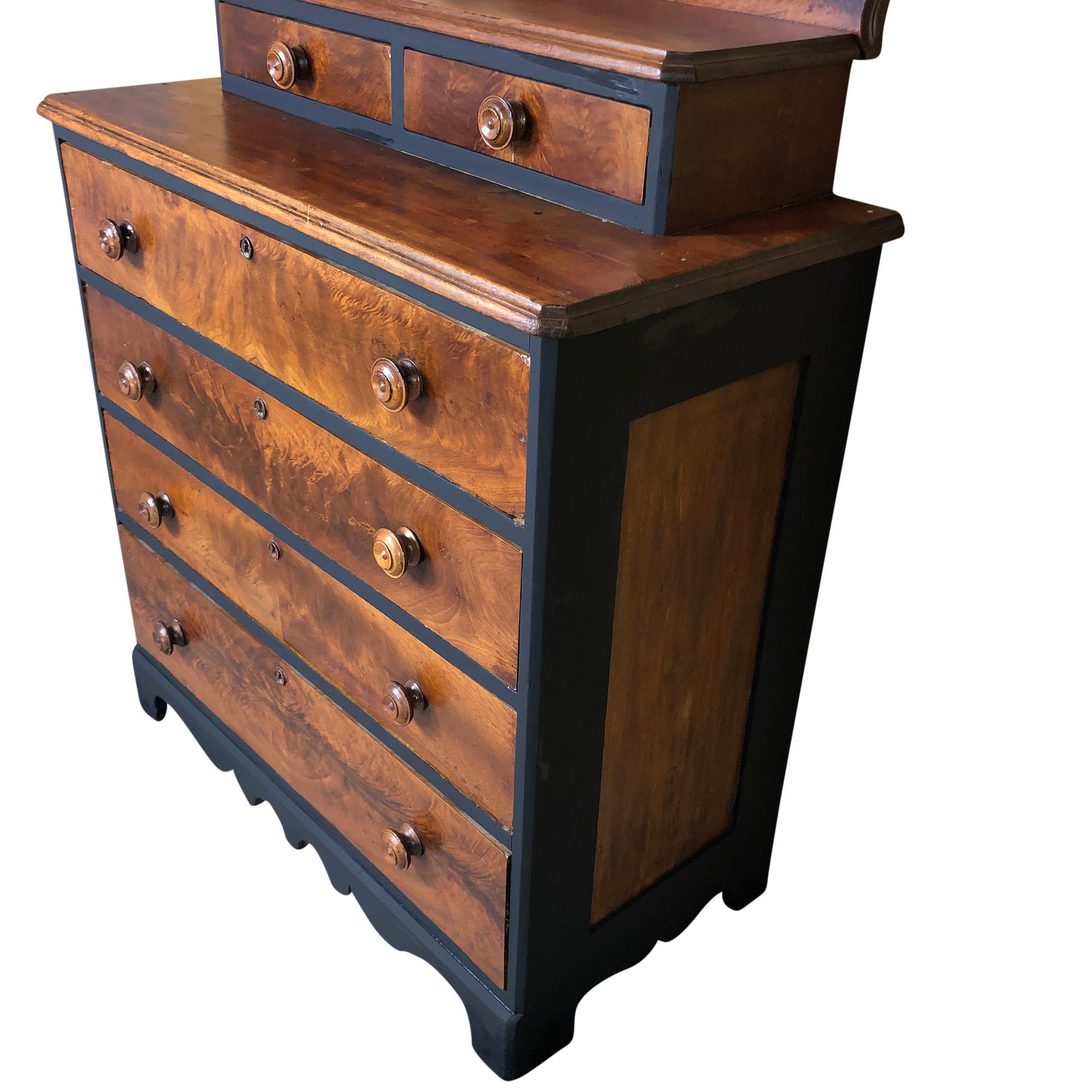 Solid wood dresser with four full drawers and two smaller drawers on top has been updated to include black accents. The stunning front drawer fronts reflect the beautiful wood grain. Features round drawer pulls and understated decorative piece on