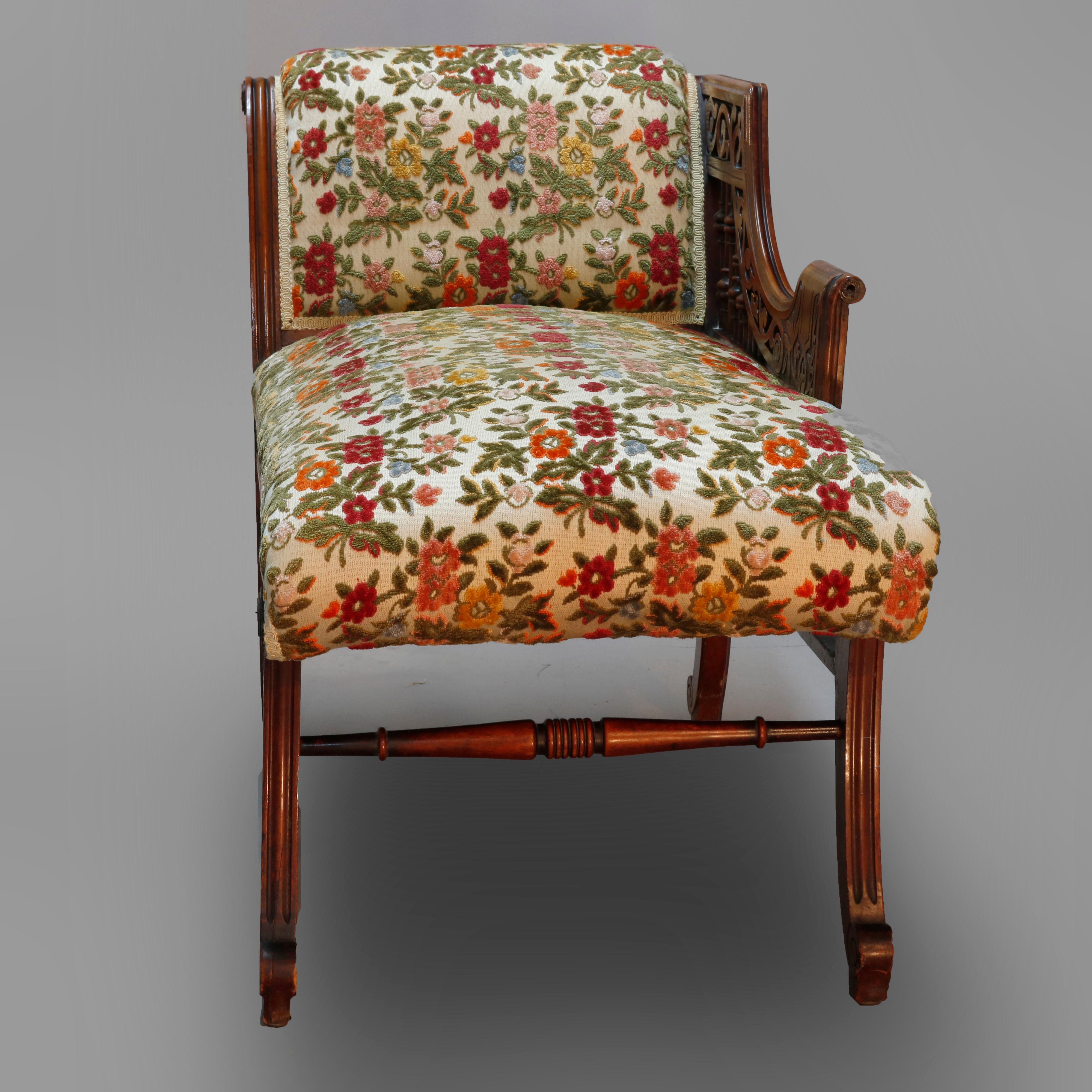 An antique Eastlake upholstered recamier offers petite form with mahogany frame having carved arm with stick and ball, scrolled back, raised on bow form legs terminating in scroll feet, circa 1900.


Measures: 28.5