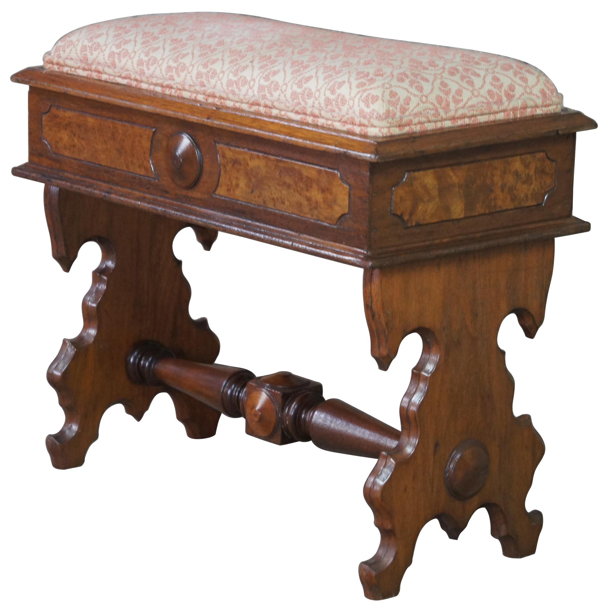 Antique Eastlake Victorian piano stool or bench, circa last quarter 19th cenutry. Made of walnut featuring rectangular form with cushioned flip top seat that opens to storage area that is encased with burled panels supported by ornate carved legs