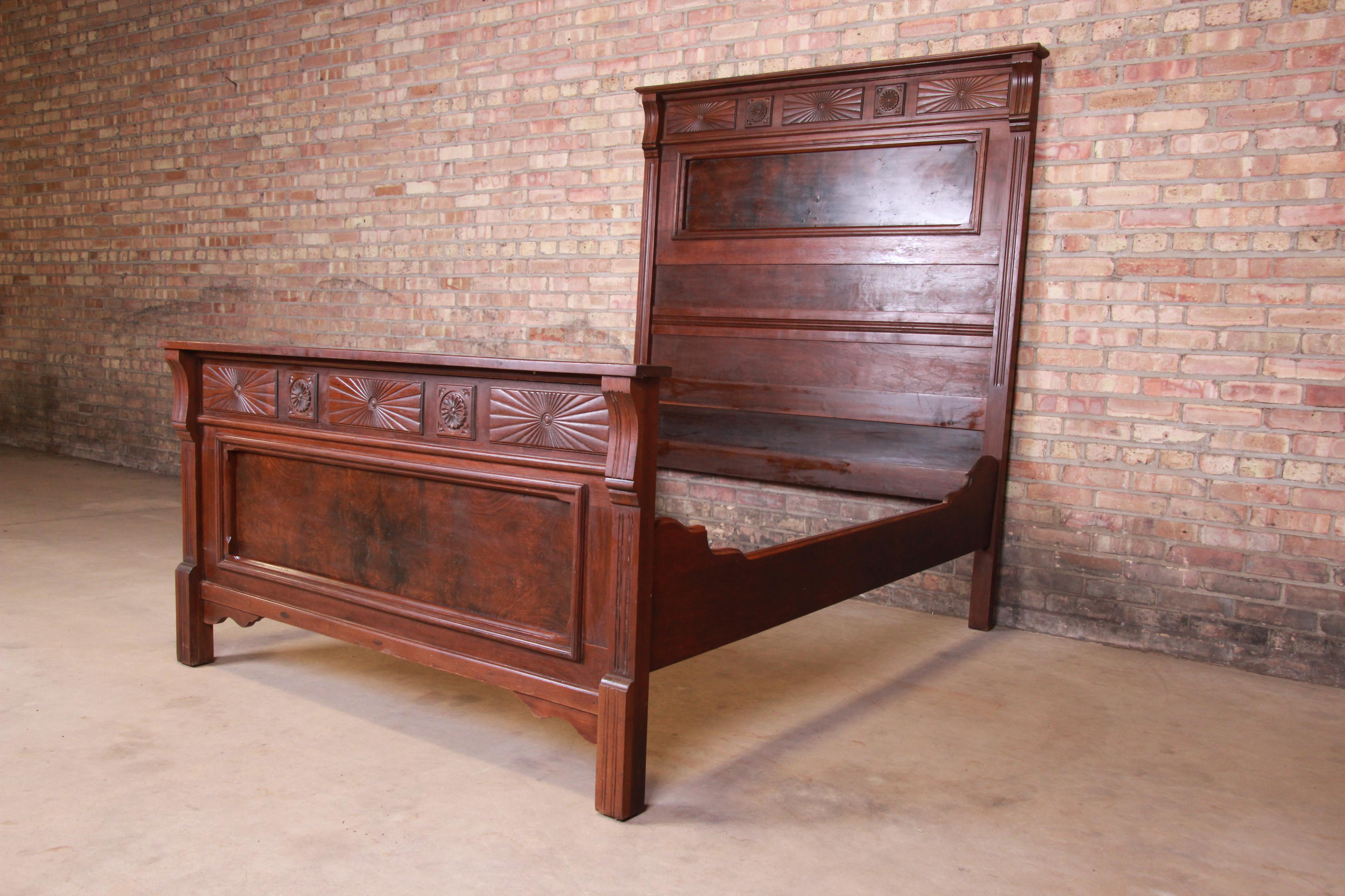 A gorgeous Eastlake Victorian full size bed frame,

USA, circa 1880s

Carved solid walnut, with burled walnut panels.

Measures: 59.5