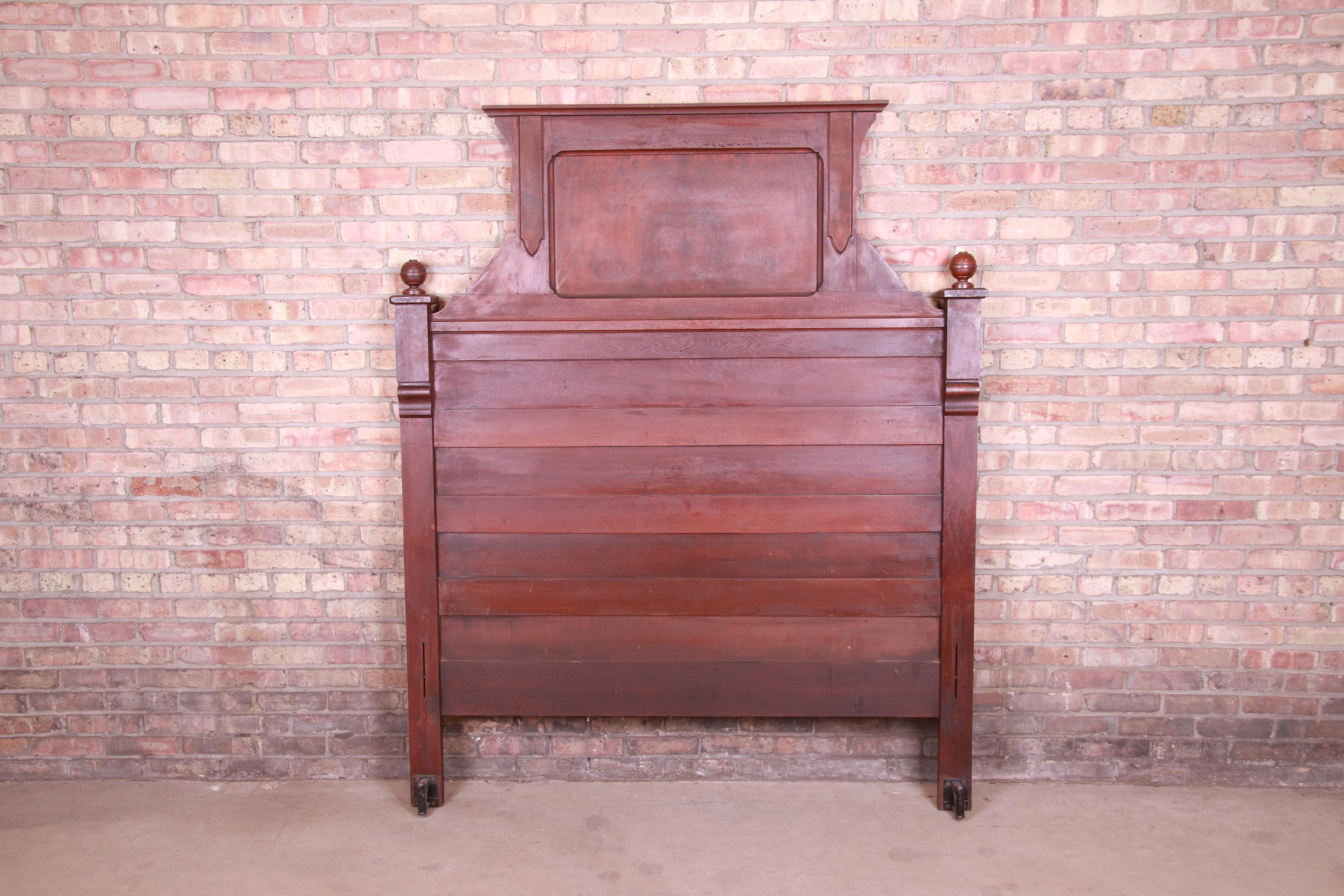 A gorgeous antique Eastlake Victorian full size tall headboard

USA, circa 1880s

Carved solid walnut, with inset burled walnut panel.

Measures: 61.13