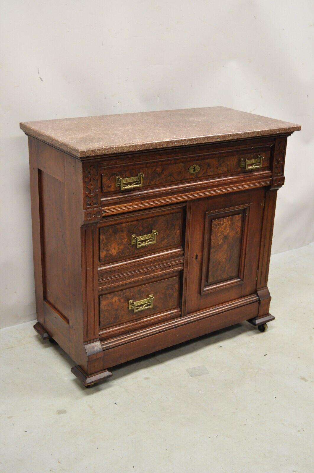 Antique Eastlake Victorian Burlwood Walnut Marble Top Washstand Nightstand Commode. Item features a marble top, beautiful woodgrain, nicely carved details, 1 swing doors, 3 drawers, very nice antique item. Circa 19th Century. Measurements: 31