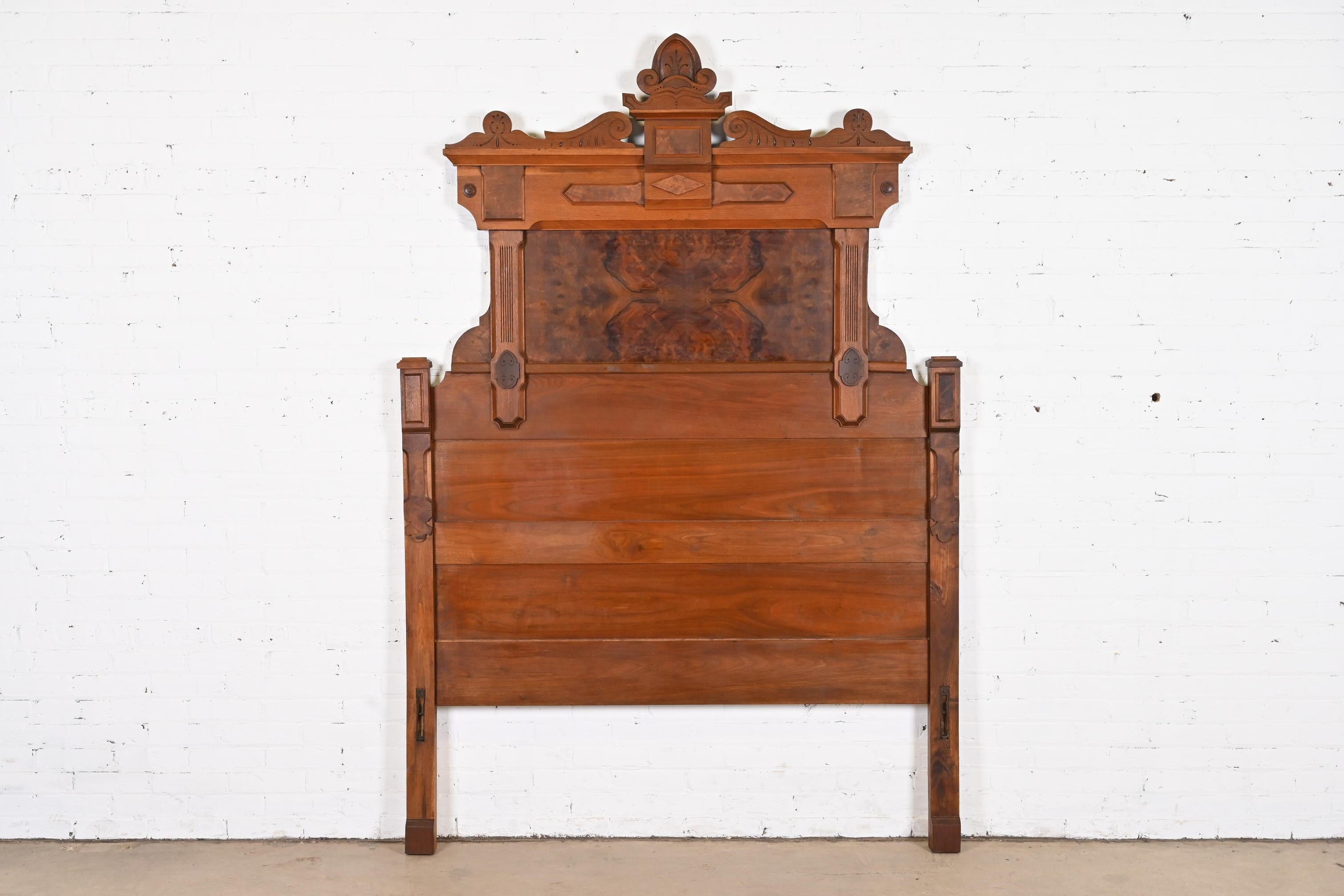An outstanding antique Eastlake Victorian monumental full size headboard

In the manner of Herter Brothers

USA, Circa 1880s

Carved solid walnut, with burled walnut panels.

Measures: 59.5