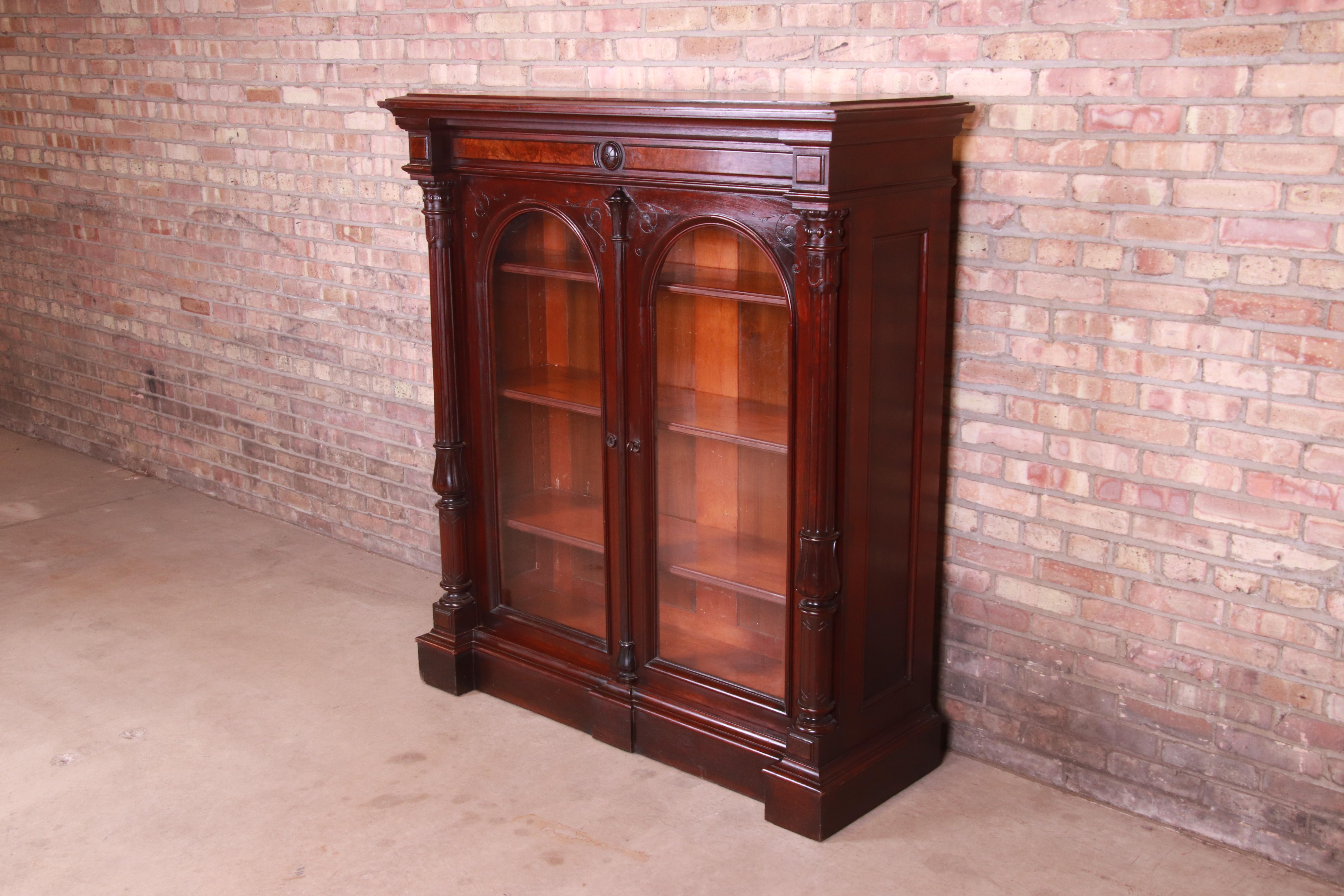 A gorgeous antique Eastlake Victorian bookcase

USA, Circa 1880s

Carved solid walnut, with burled walnut accents and glass front doors. Cabinet locks, and key is included.

Measures: 53.25