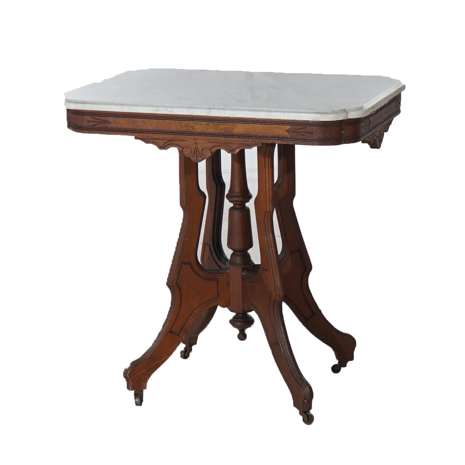 Antiker viktorianischer Eastlake Tisch mit geschnitztem Nussbaum und Wurzelholz mit abgeschrägter Marmorplatte über stilisierten Beinen in Form einer Schnecke mit zentralem Abschluss, um 1890

Maße - 29 3/4