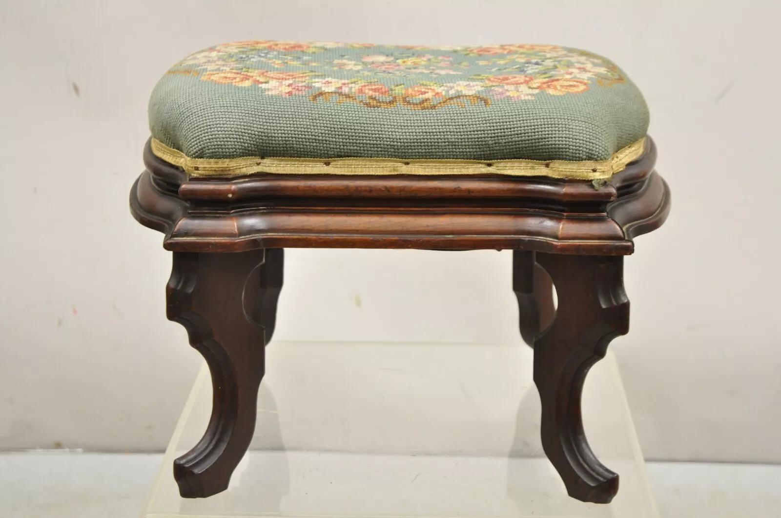 Antique Eastlake Victorian Carved Walnut Floral Needlepoint Footstool Ottoman with Shapely Legs. Circa Late 19th Century. Measurements: 13