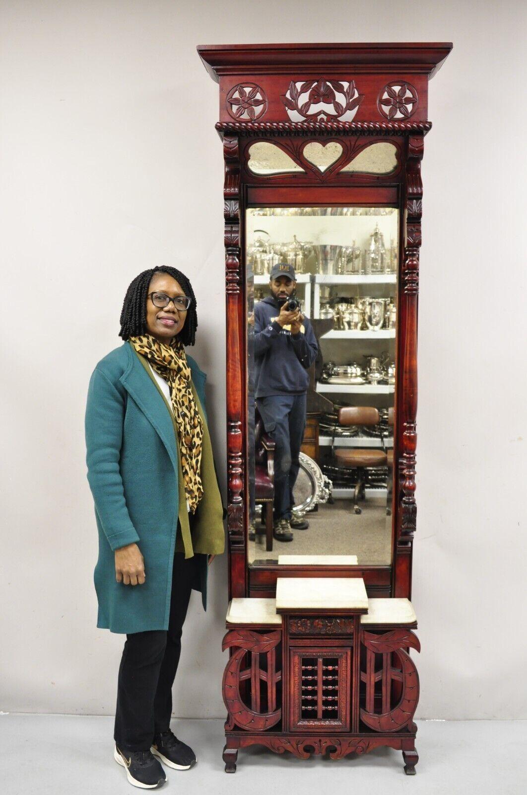 Antique Eastlake Victorian Carved Walnut & Marble Tall Pier Mirror Hall Tree. Item featured is a tall impressive size, nice narrow depth, lower swing stick and ball door, carved and mirrored 