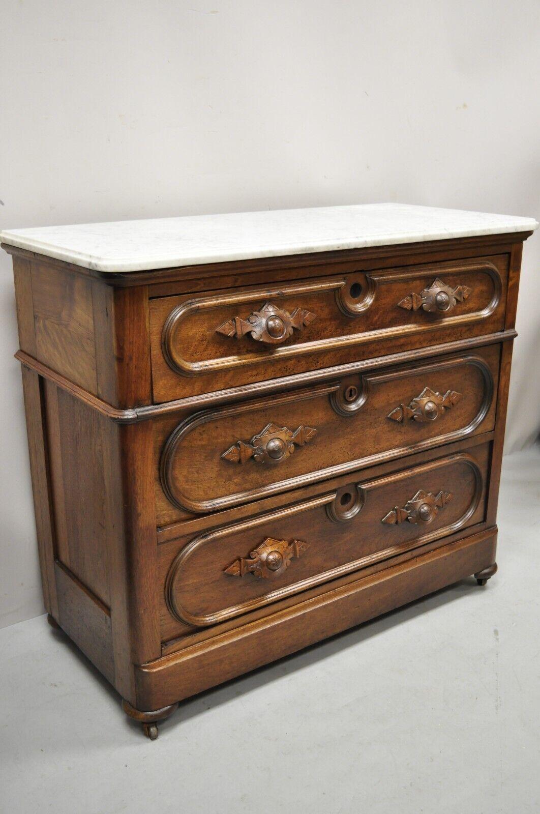 Antique Eastlake Victorian Carved Walnut Marble Top Dresser Chest Washstand. Item features carved wood drawer pulls, rolling casters, marble top, solid wood construction, beautiful wood grain, nicely carved details, no key, but unlocked,3 dovetailed