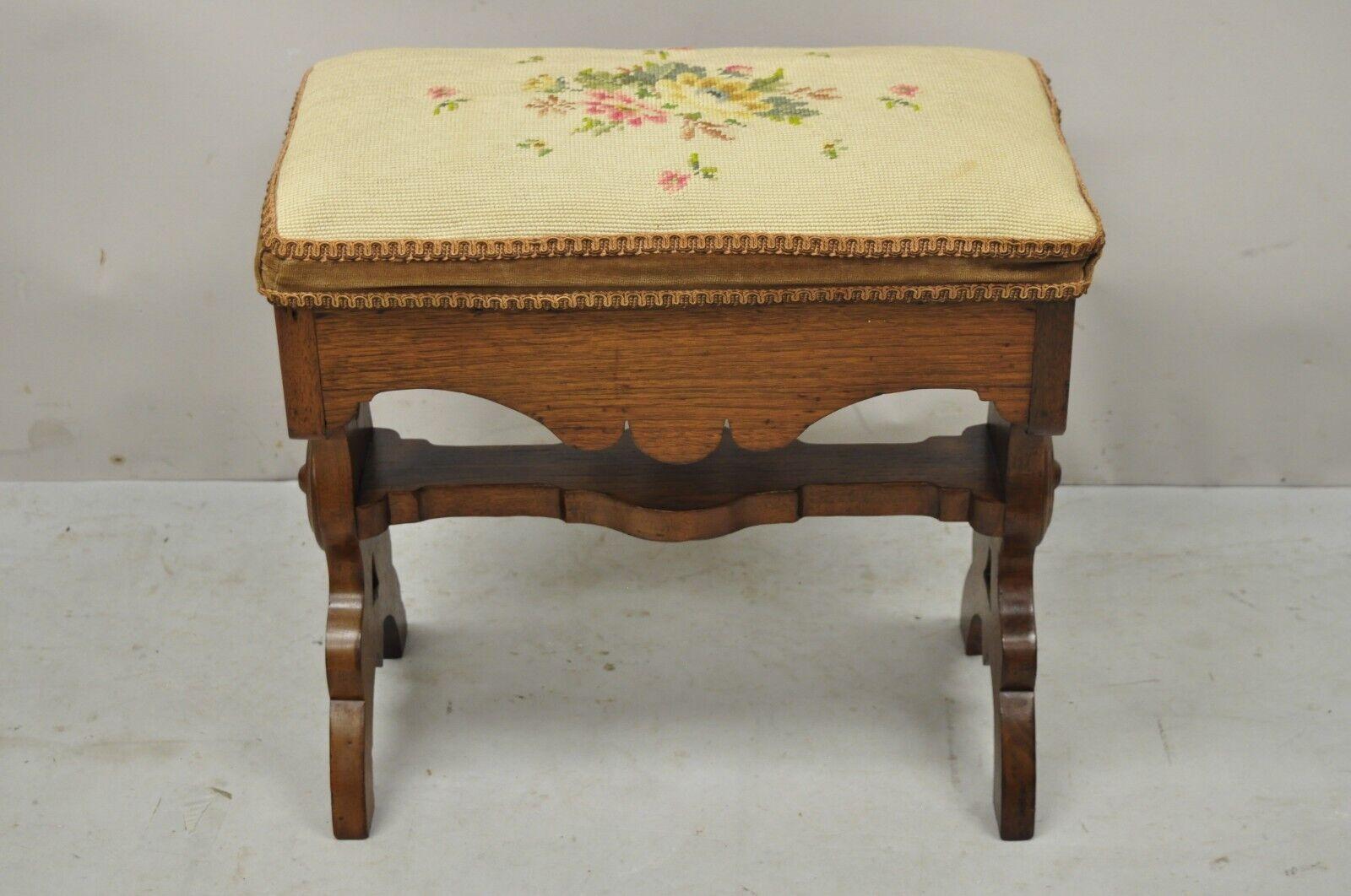 Antique Eastlake Victorian carved walnut stool bench with needlepoint seat. Item features a needlepoint seat, stretcher base, solid wood frame, beautiful woodgrain, nicely carved details, very nice antique item. Circa19th century. Measurements: 18