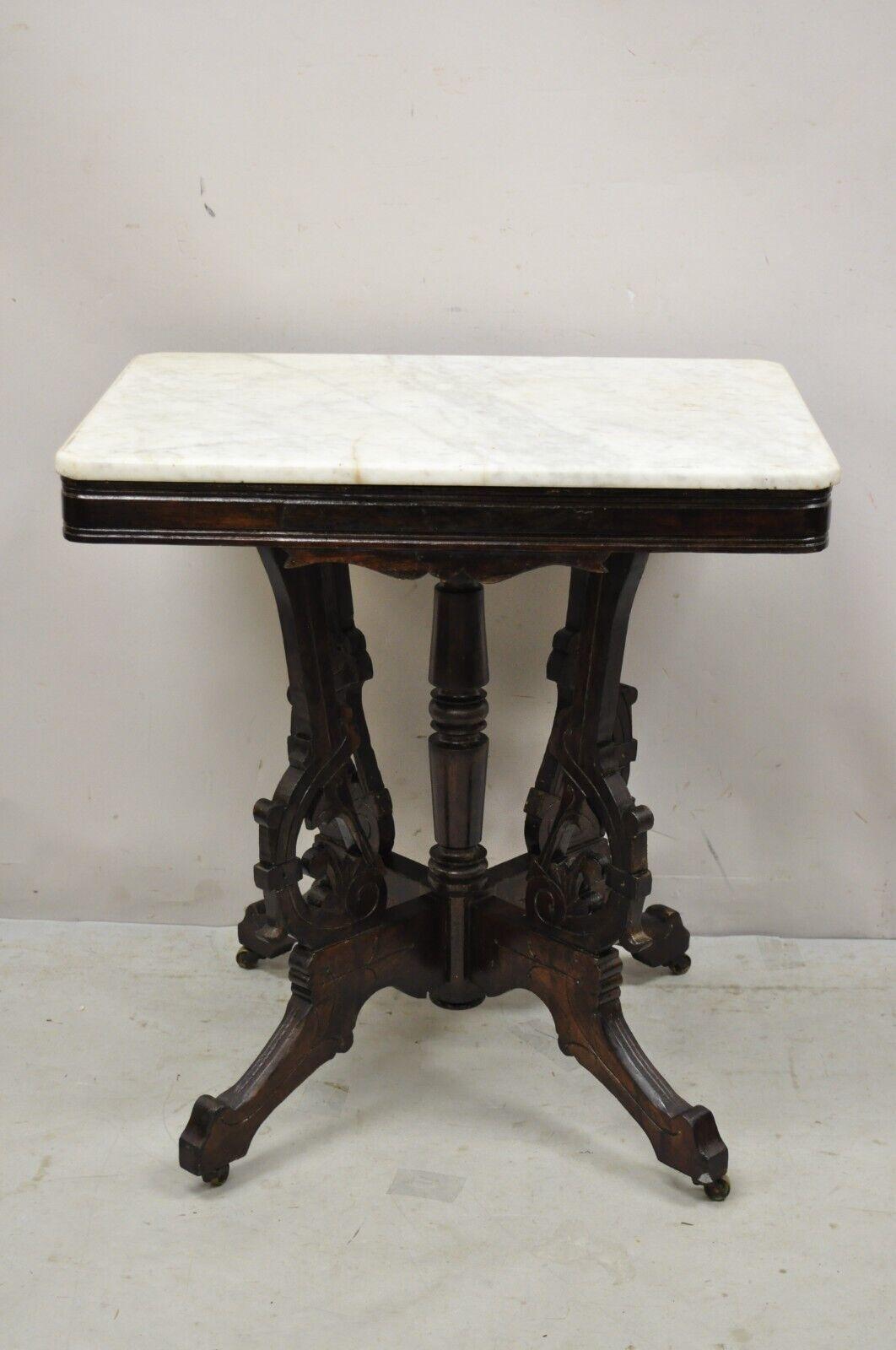 Antique Eastlake Victorian marble top walnut parlor accent side table. Item features a marble top, carved walnut base, very nice antique item. circa 19th century. Measurements: 29.5