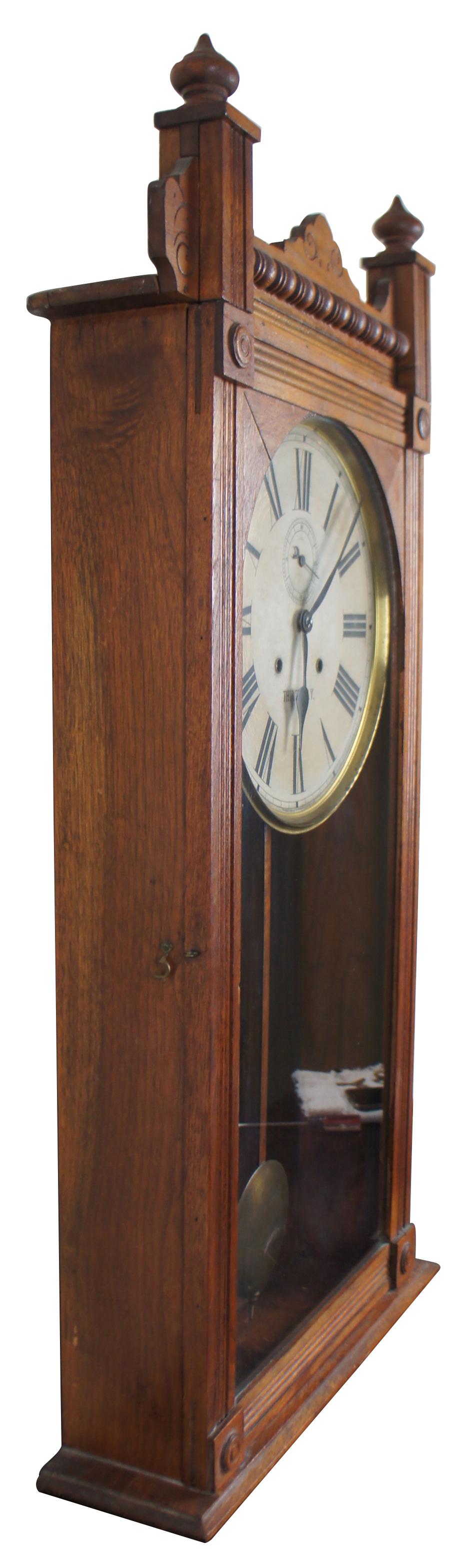 Antique Waterbury Clock Co. Cambridge Thirty Day Model Clock, circa 1890s.  Features a long walnut case with Eastlake carvings.  A double wind face that times with second hand.  No.607
