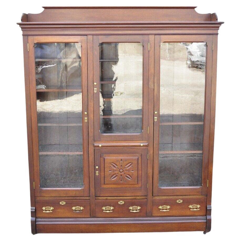 Antique Eastlake Victorian Walnut Wavy Glass Triple Bookcase Display Cabinet For Sale
