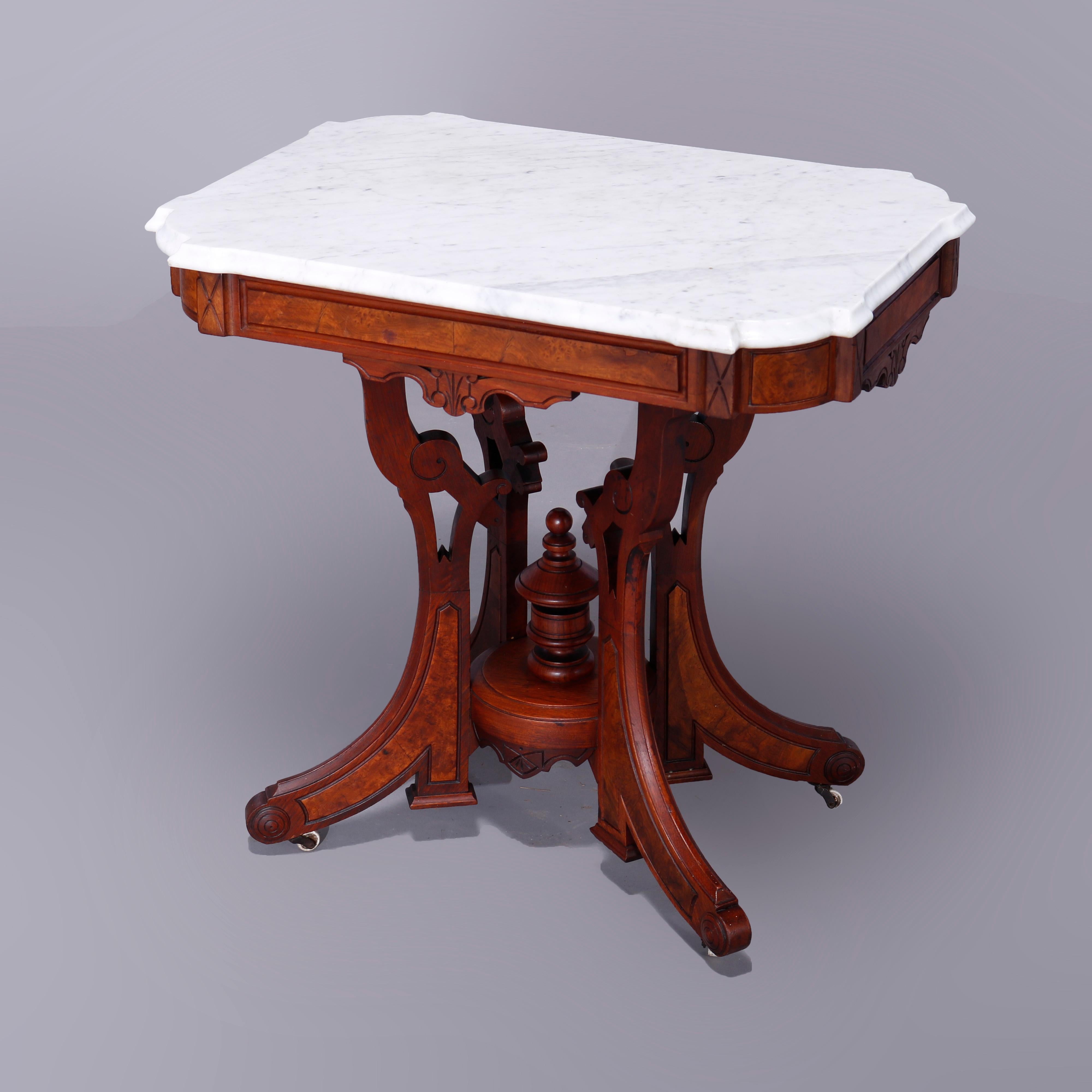 An antique Eastlake parlor table offers shaped stylized clip-corner and beveled marble top over walnut and burl base having shaped skirt and raised on scroll form legs with central urn form finial, c1890

Measures- 28''H x 29''W x 20.75''D.
