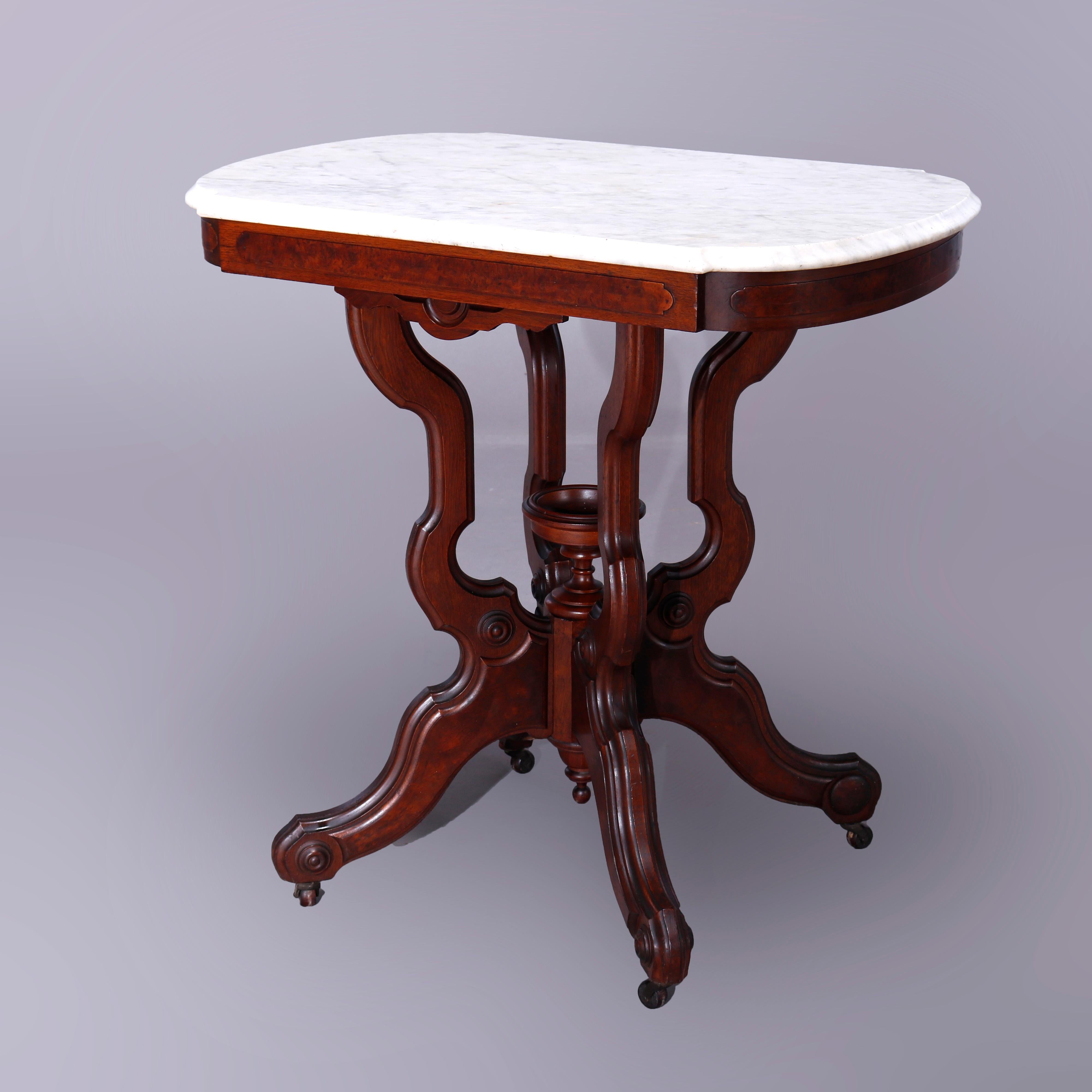 An antique Eastlake parlor table offers shaped and beveled marble top over walnut and burl base having shaped skirt and raised on scroll form legs with central urn form finial, c1890

Measures - 31''H x 31''W x 21.25.