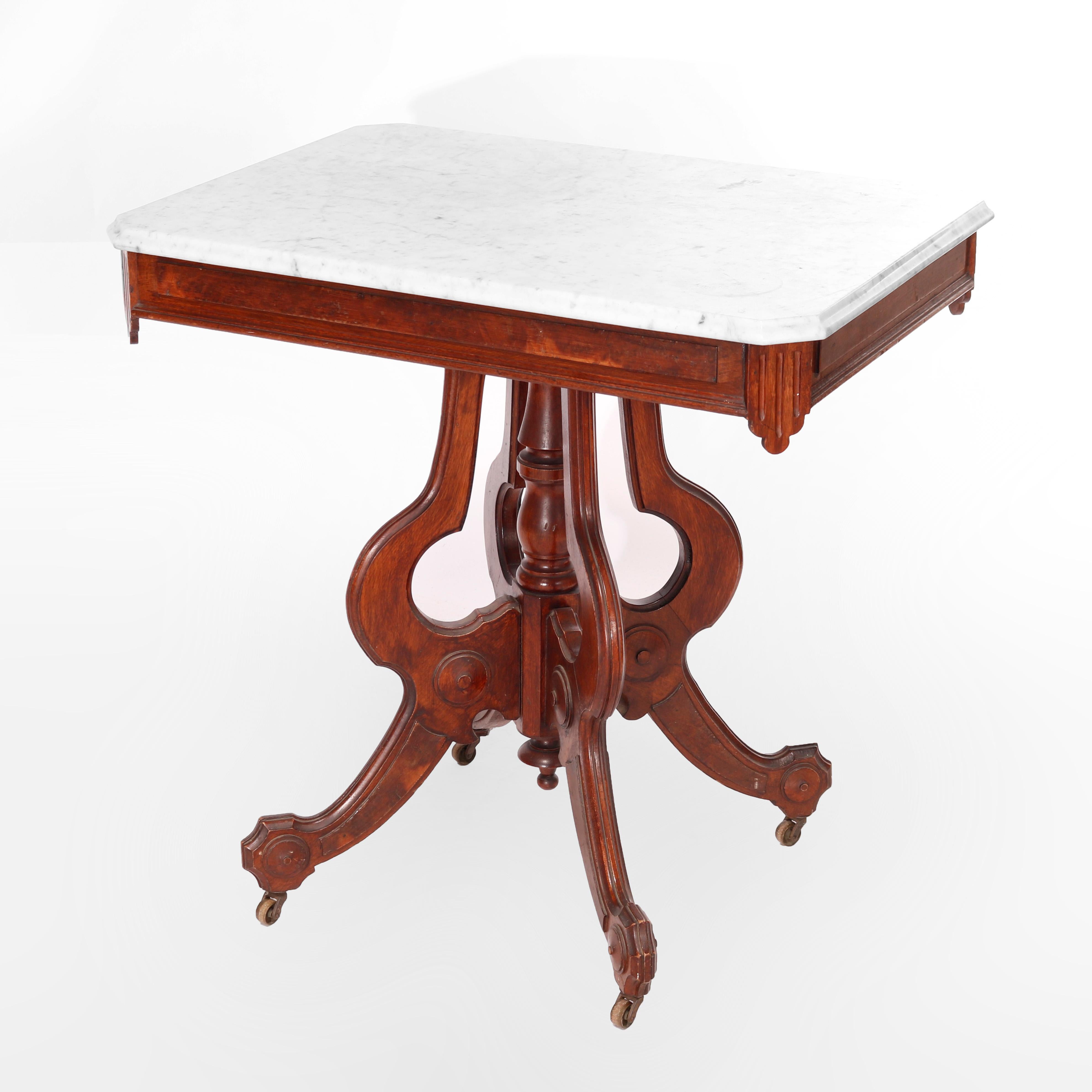 An antique Eastlake parlor table offers clip corner beveled marble top surmounting walnut base having burl reserves, raised on 
cabriole legs having turned center column, c1890

Measures - 29.25''H x 29.25''W x 21''D.

Catalogue Note: Ask about