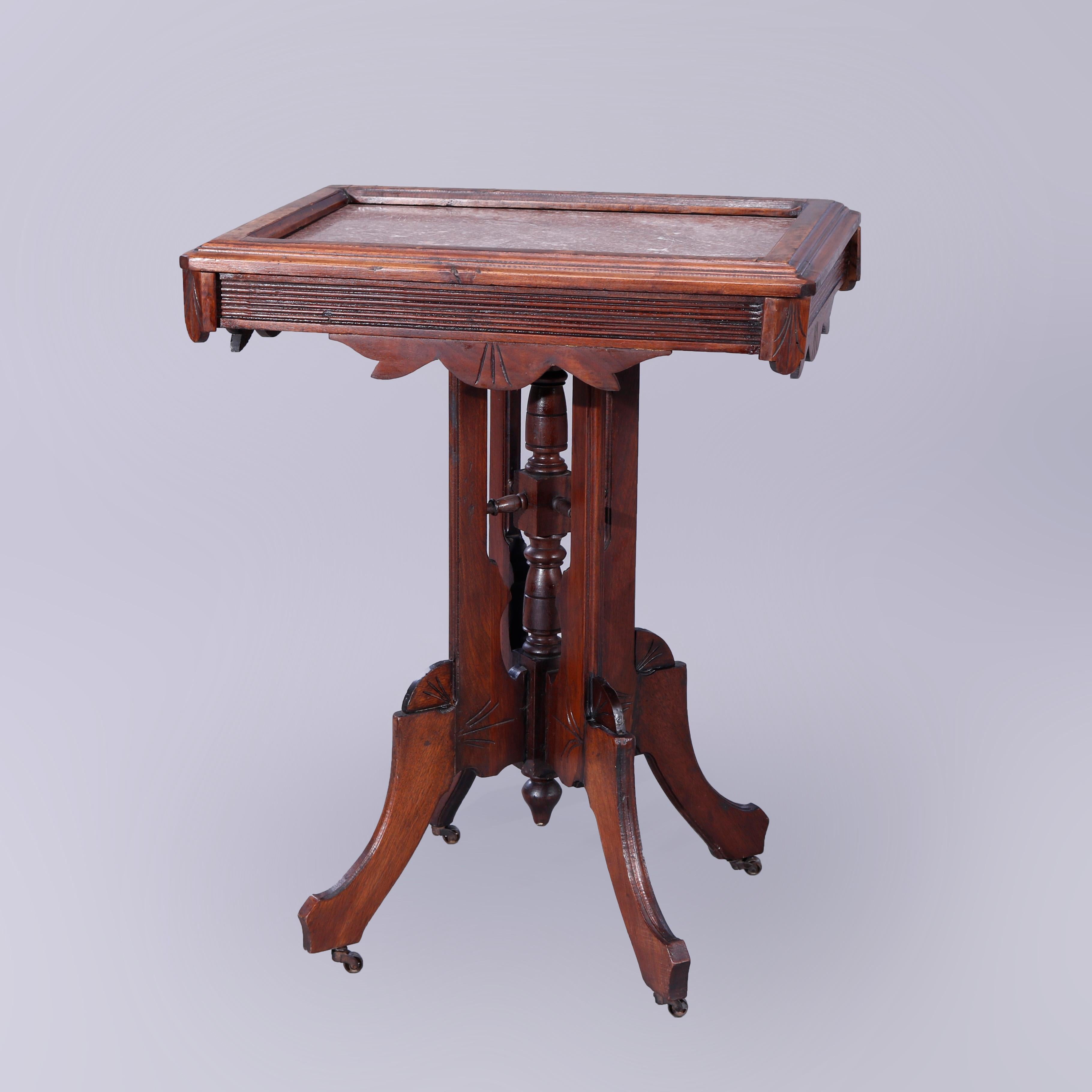 An antique Eastlake parlor table offers rouge marble in walnut base with picture frame top over reeded and shaped skirt raised on legs with central turned column and drop finial, c1890

Measures - 30.25'' H x 24'' W x 18.5'' D.

Catalogue Note: Ask