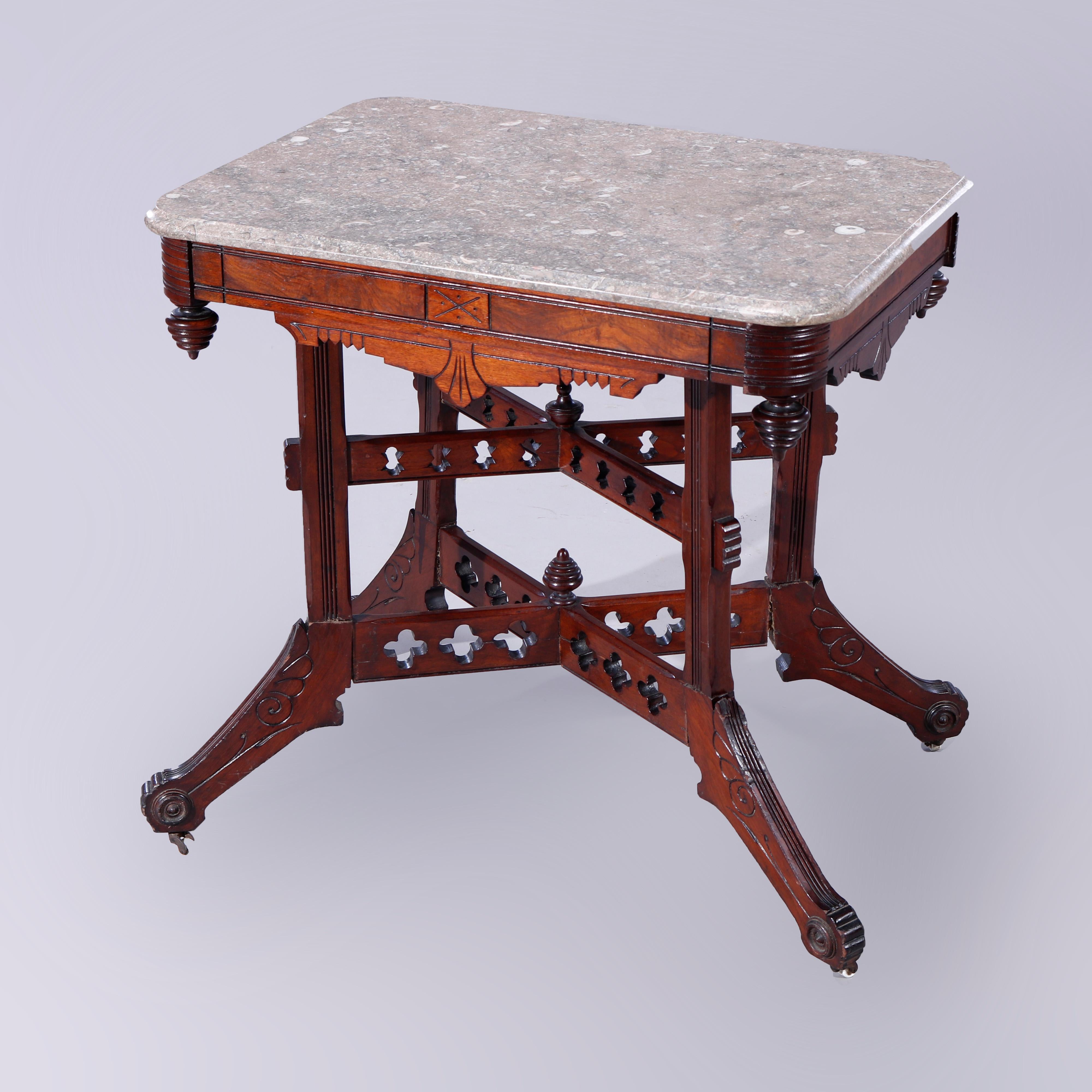 Antique Eastlake parlor table offers beveled specimen marble top over walnut base with incised decoration, beehive drop finials and and pierced x-stretchers, c1890

Measures - 29.75'' H x 30'' W x 22'' D.

Catalogue Note: Ask about DISCOUNTED