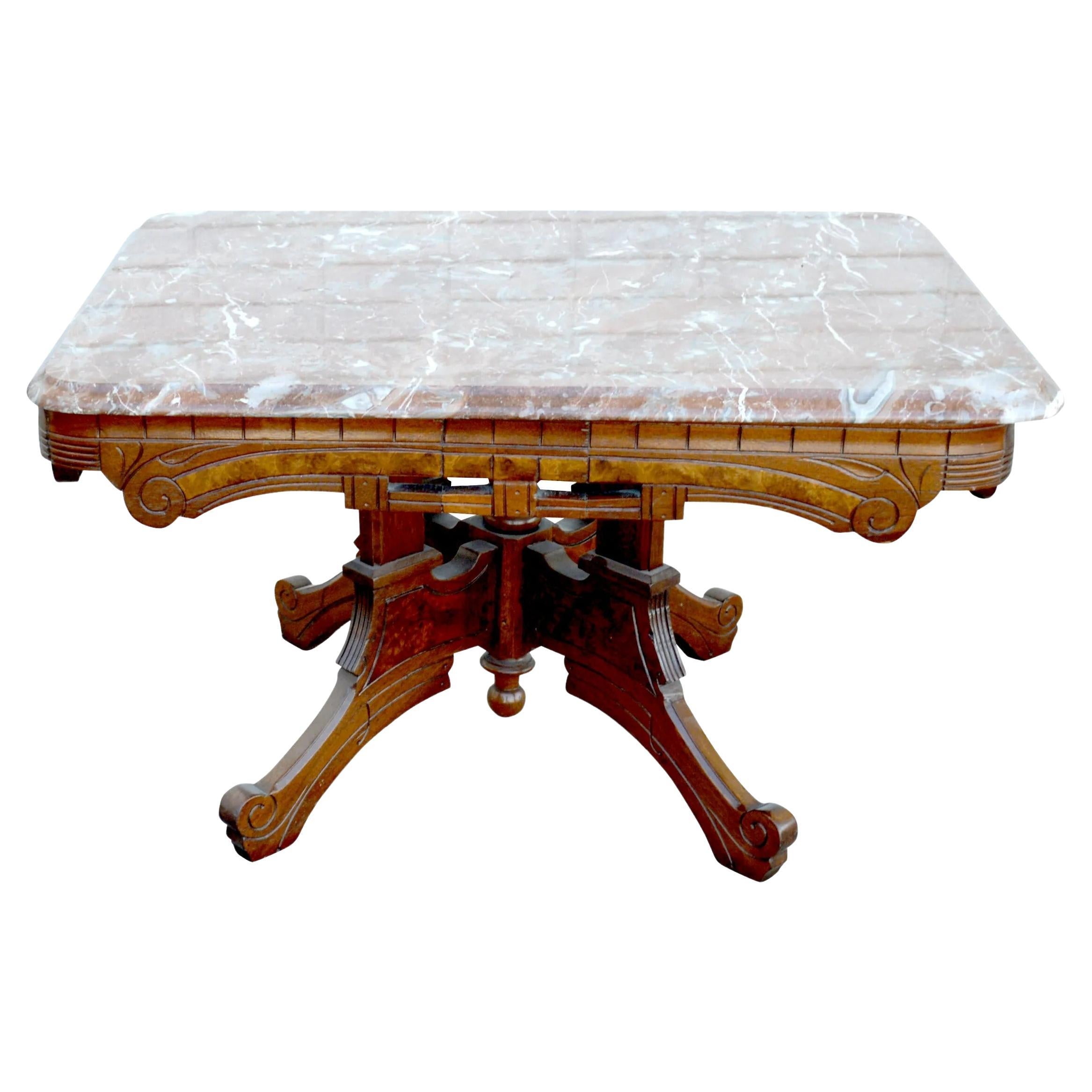 Antique Victorian Eastlake Coffee Table

Carved and incised walnut with a beveled Breccia marble top in rich amber, grey and cream tones.
The base features scalloped aprons and four shaped legs with a turned center column and drop finial.
 