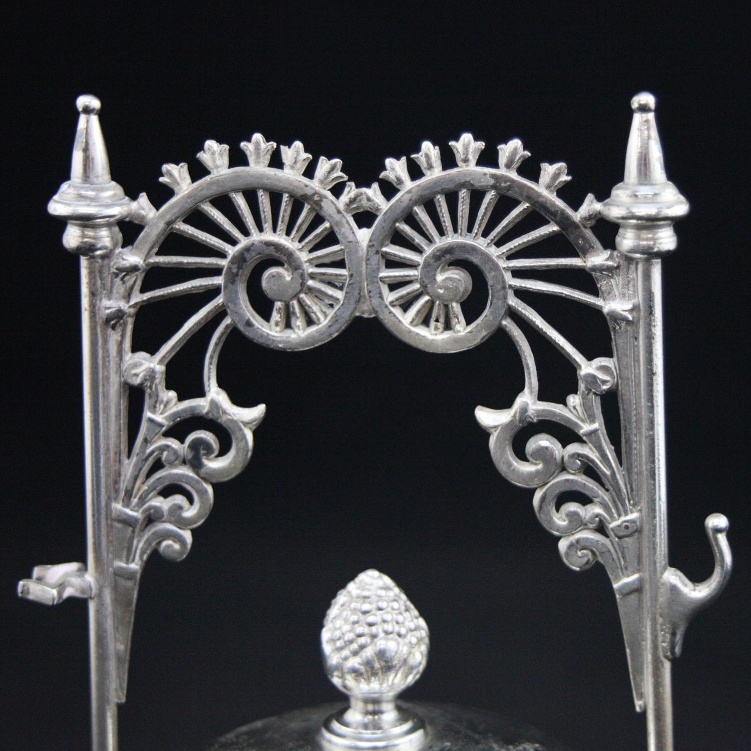 An antique Eastlake Wilcox Silver Plate Co. pickle caster features footed frame with pierced scrolled nautilus shell form handles and pressed glass jar having silver plate lid with acorn finial, circa 1898

***DELIVERY NOTICE – Due to COVID-19 we