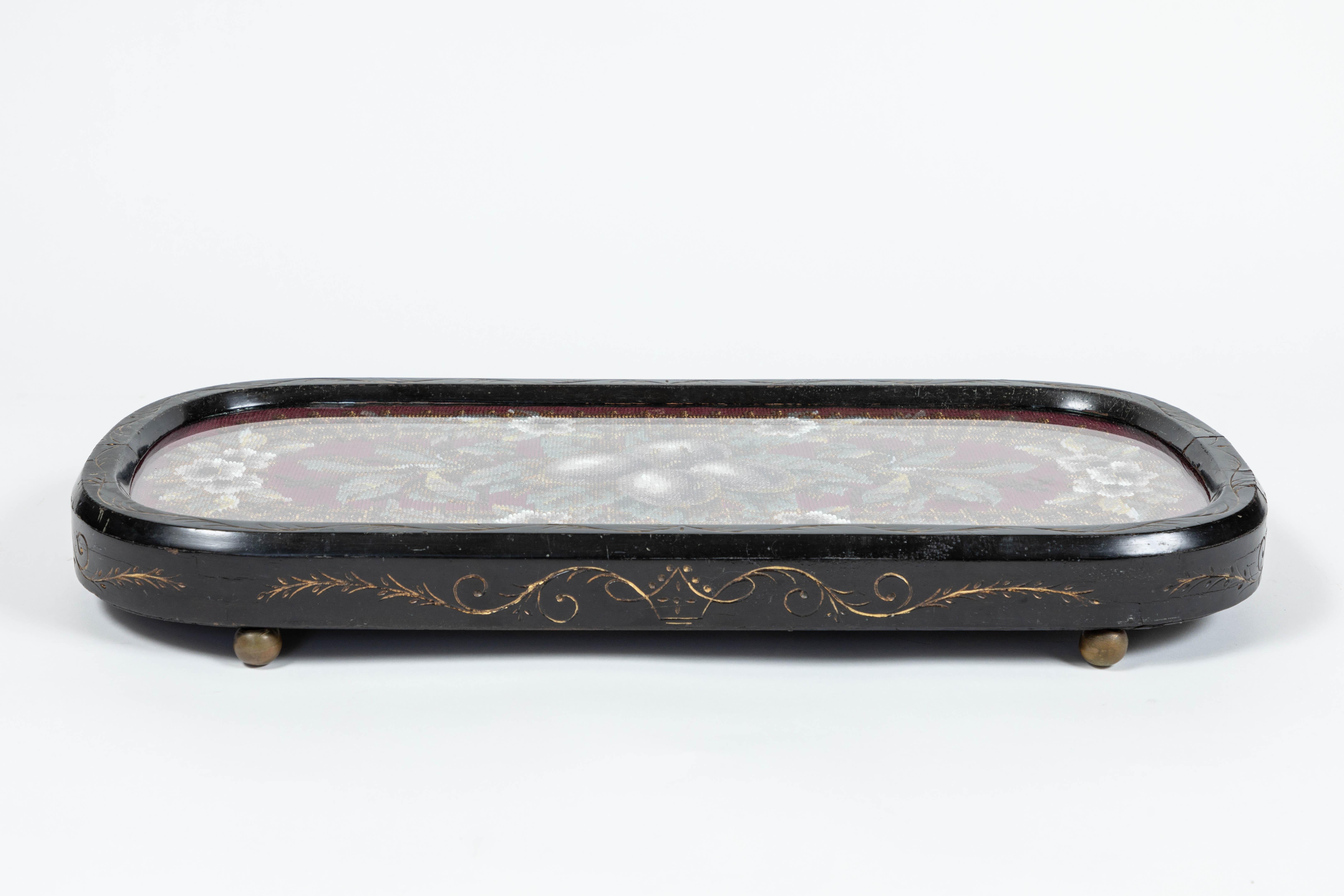 Antique Eastlake wood tray with beaded needlepoint panel under glass, circa 1850-1880.
