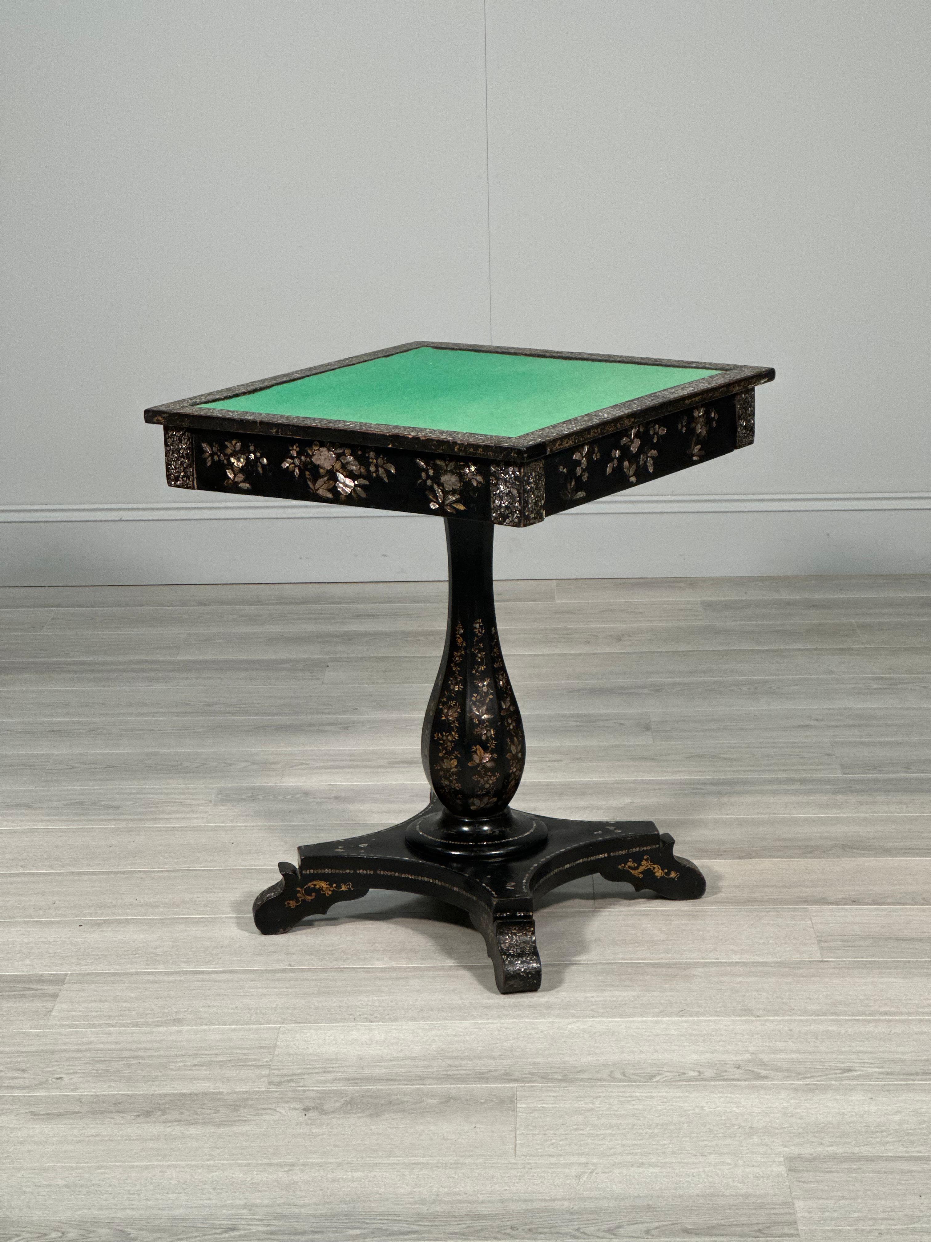 Antique ebonised papier mache mother of pearl games table dating to the second half of the 19th century. The table has an oak frame with a papier mache and mother of pearl ebonised finish with a oak lined drawer to one side. The table is in very