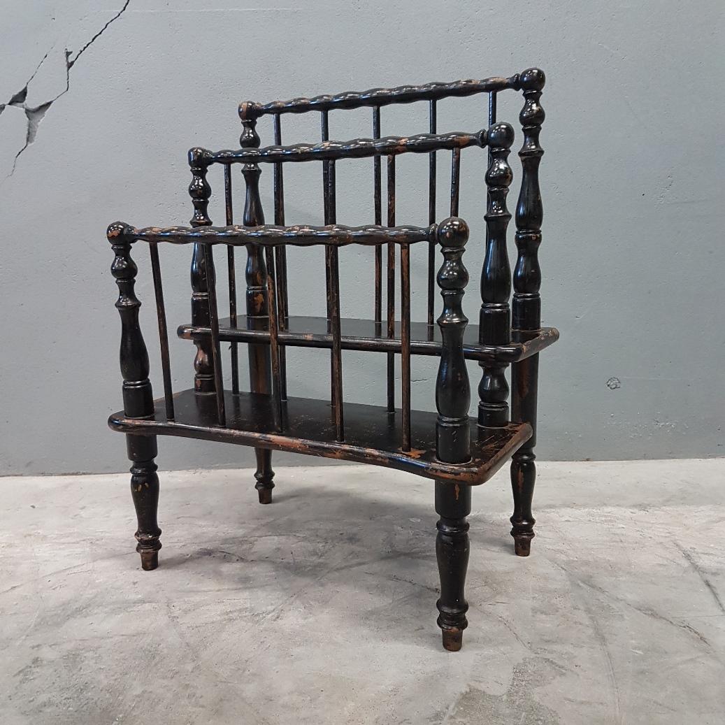 Antique ebonized bobbin Canterbury magazine rack, circa 1860
with paint damage.