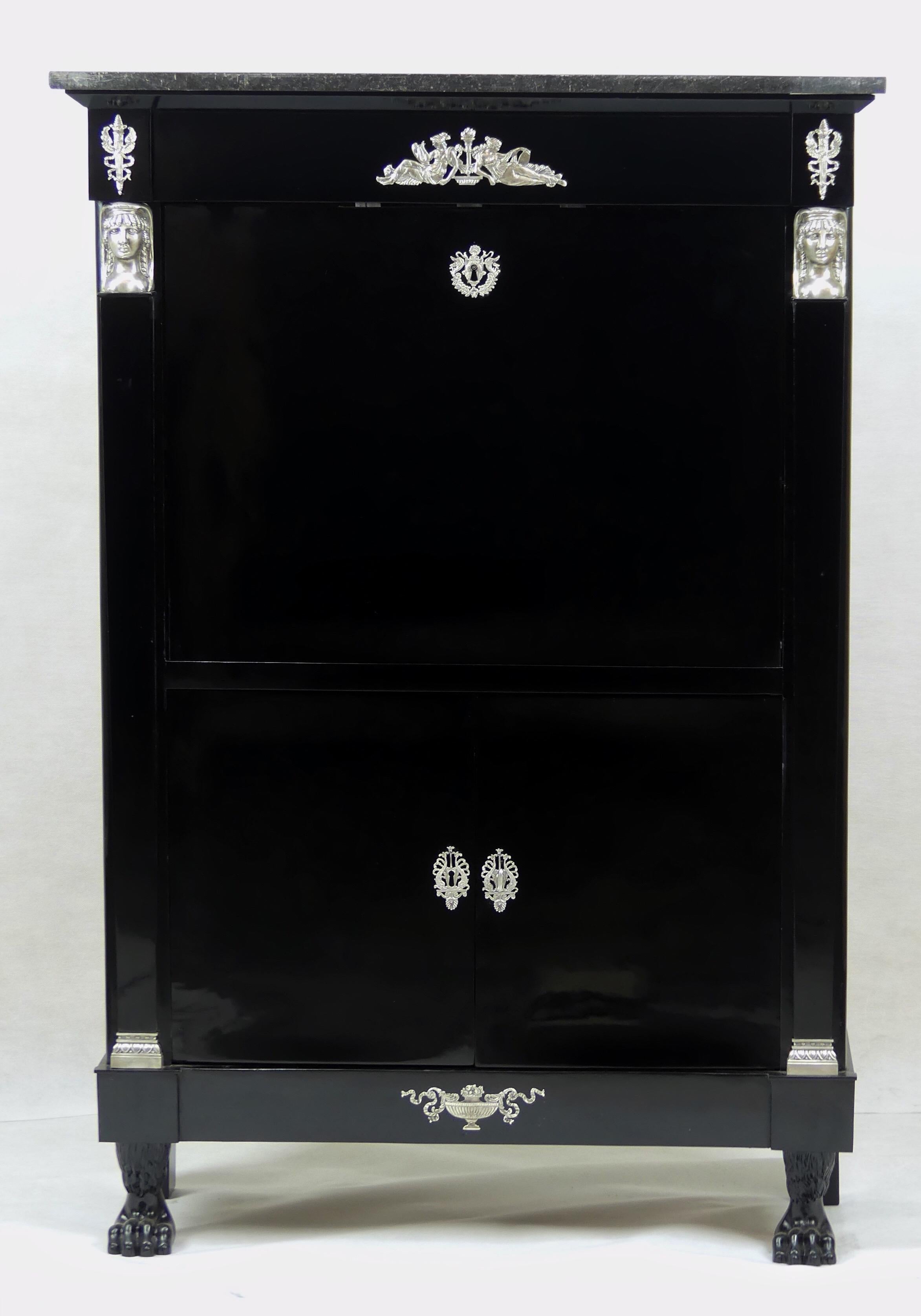 An original antique Empire secretary from the early 19th century from France. The secretary is ebonized and has wonderful silver plated fittings.

The secretary has two main compartments and an original marble top. The first compartment covers the