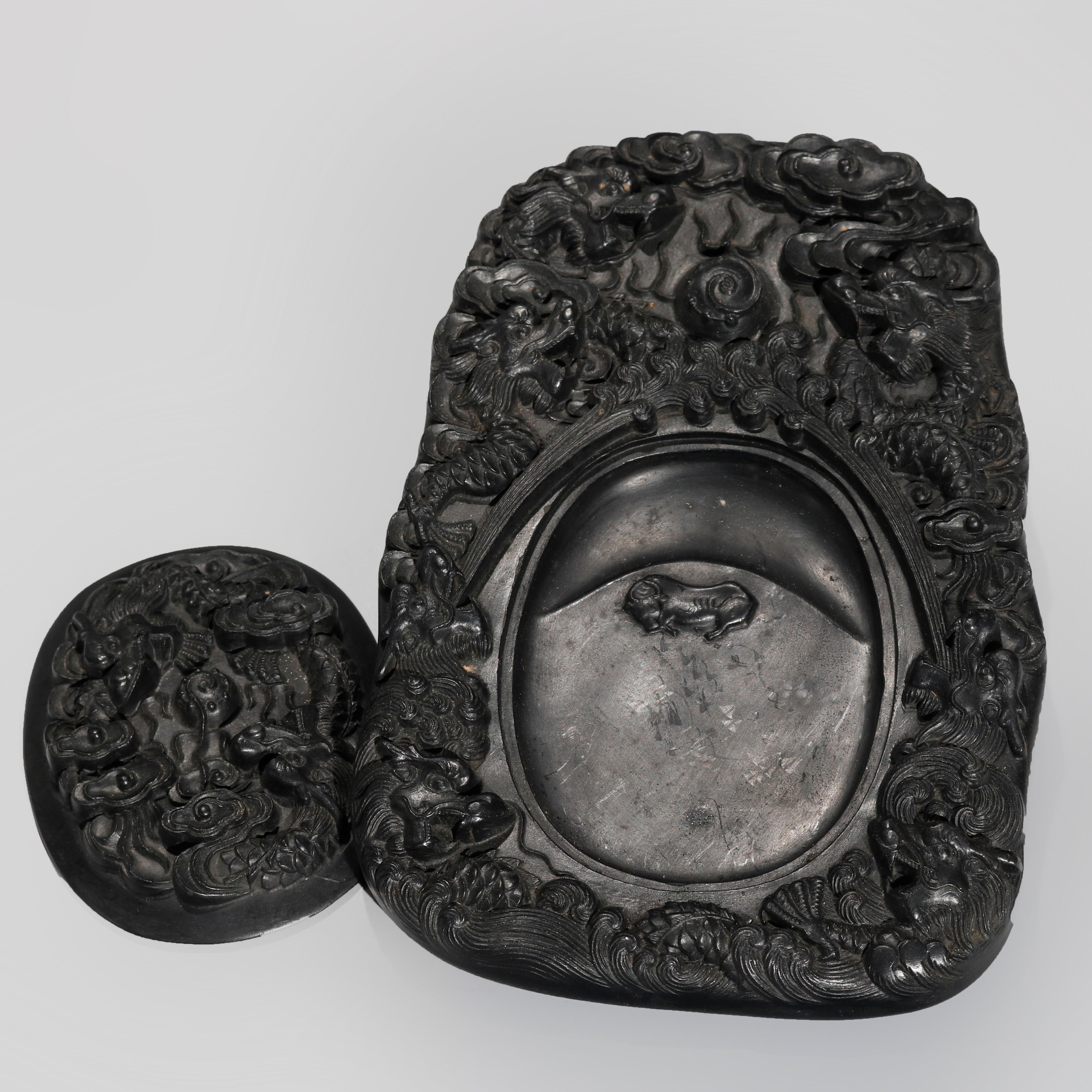 An antique Chinese censer offers ebony stone construction with all-over carved dragon design, includes base and lid, 20th century

Measures: 9.25