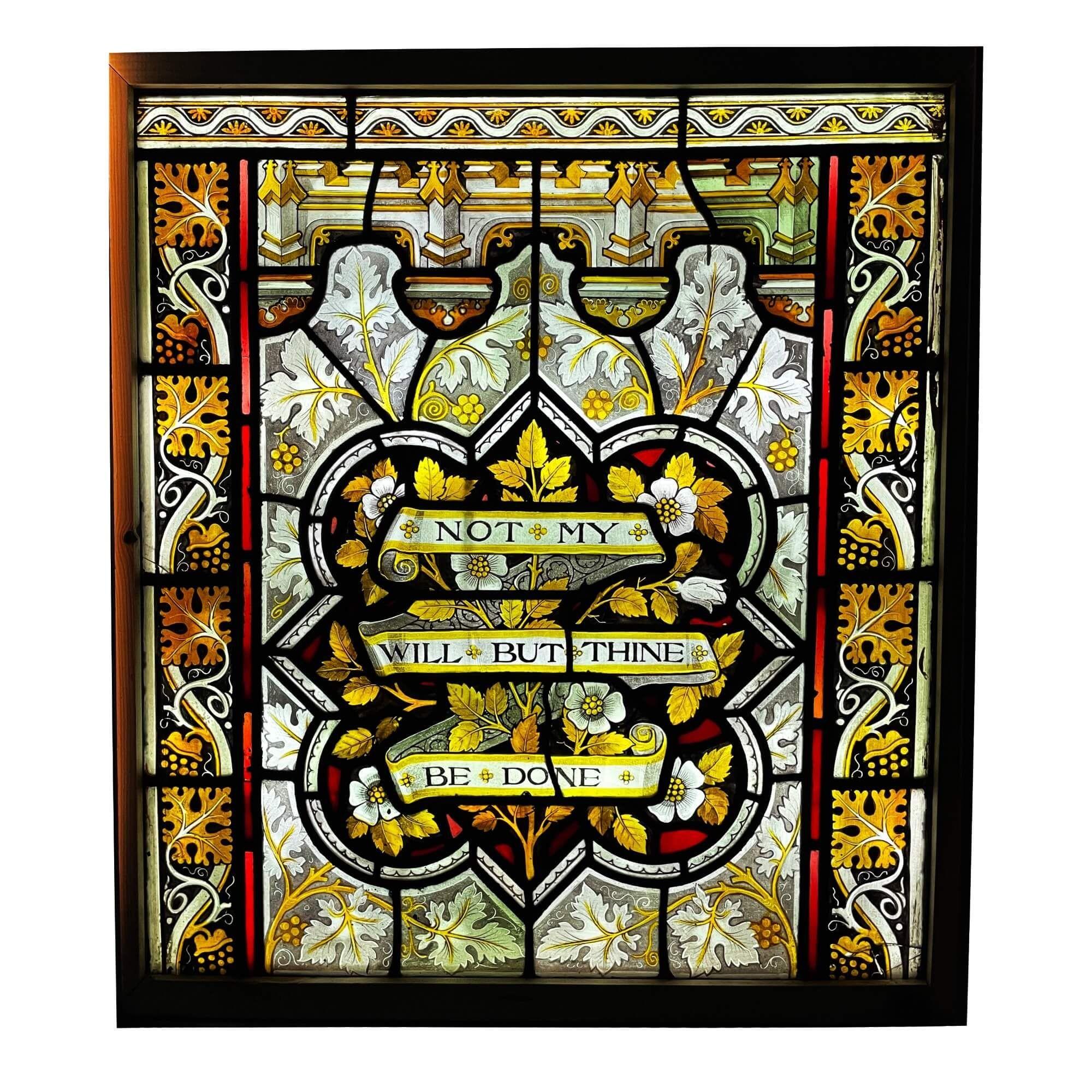An antique ecclesiastical style stained glass window painted with the religious quote 