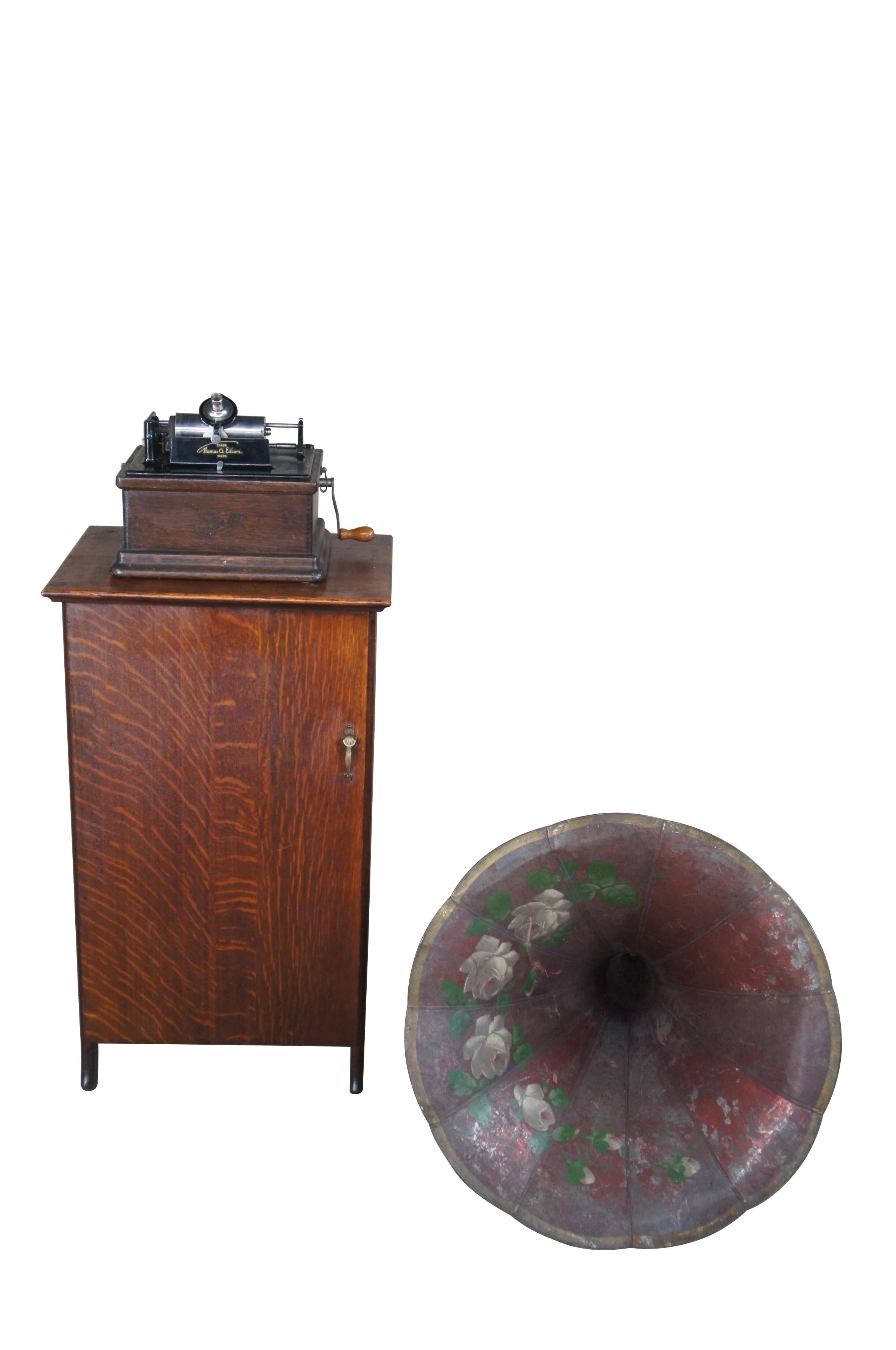 An exception Early Thomas Edison Model A Cylinder Phonograph with original horn, tube cabinet & 93 records.  Phonograph box and cabinet are made from oak in Late Victorian manner with a few quartersawn boards.  Horn is red with hand painted motifs. 