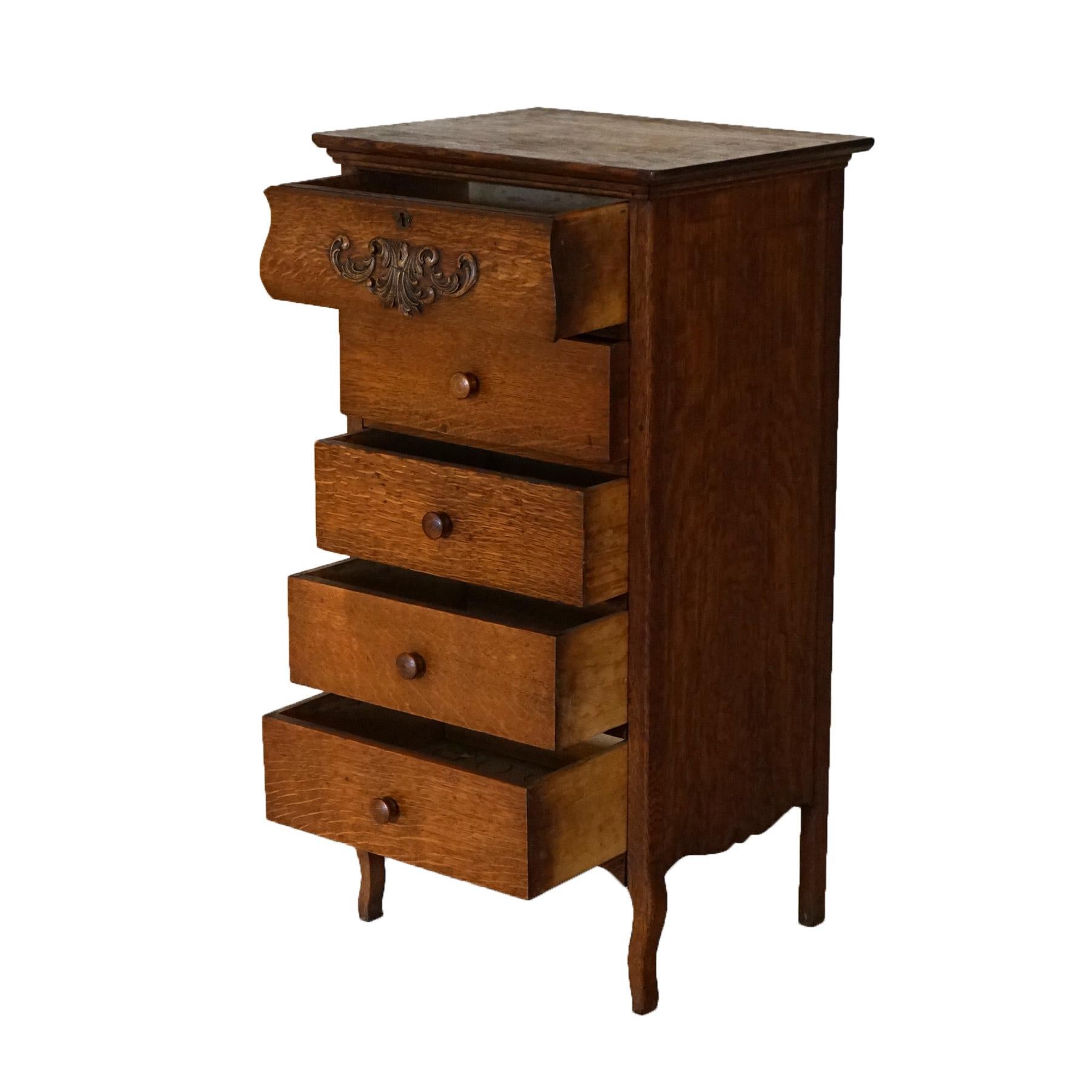 An antique Edison phonograph cylinder cabinet offers oak construction with five drawers, the top having carved foliate decoration, and raised on cabriole legs, c1920

Measures- 37''H x 19.5''W x 15.75''D