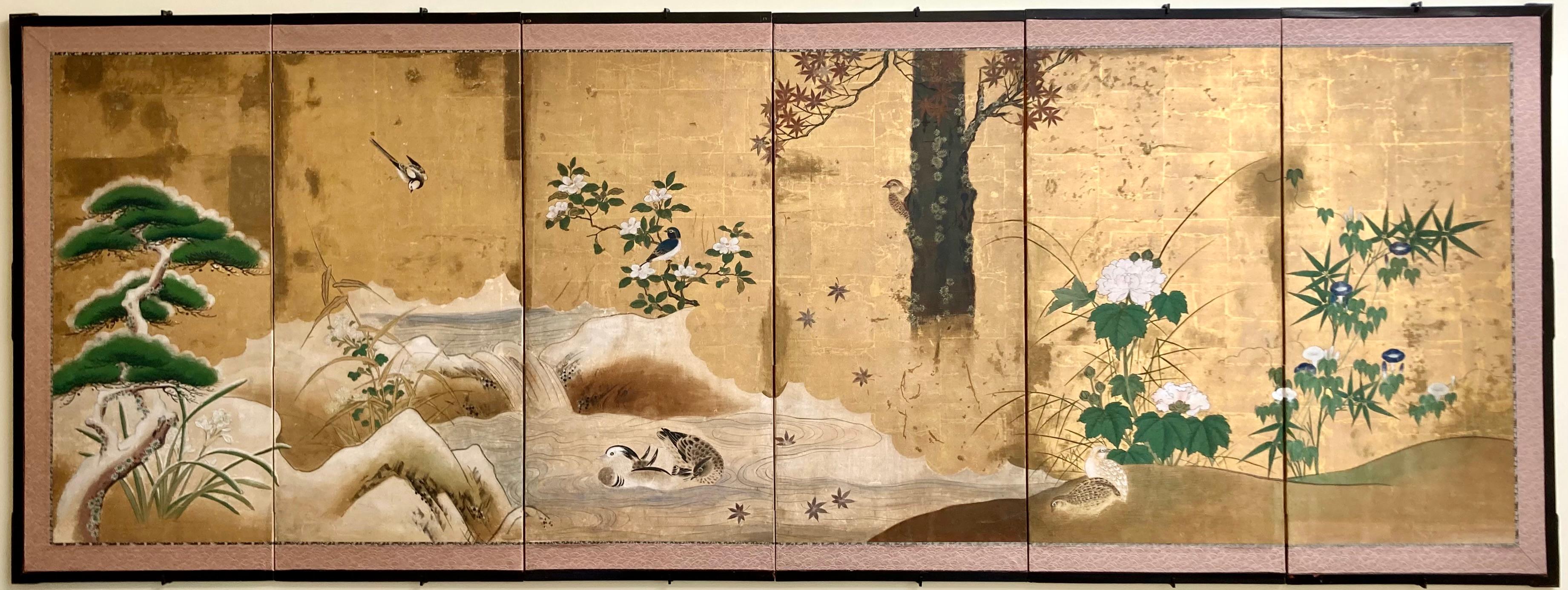 A fine Edo (Tokugawa) period Japanese antique six panel folding screen in sumi (black ink) and colors on gold leaf applied paper, mounted on wooden frames with paper hinges, the textile border with lacquered molding. The screen depicts pairs of